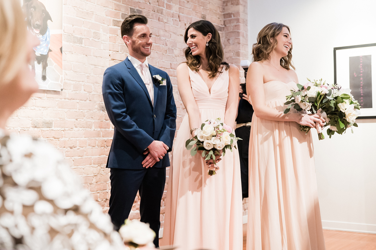 Bridal party reacts during wedding ceremony.