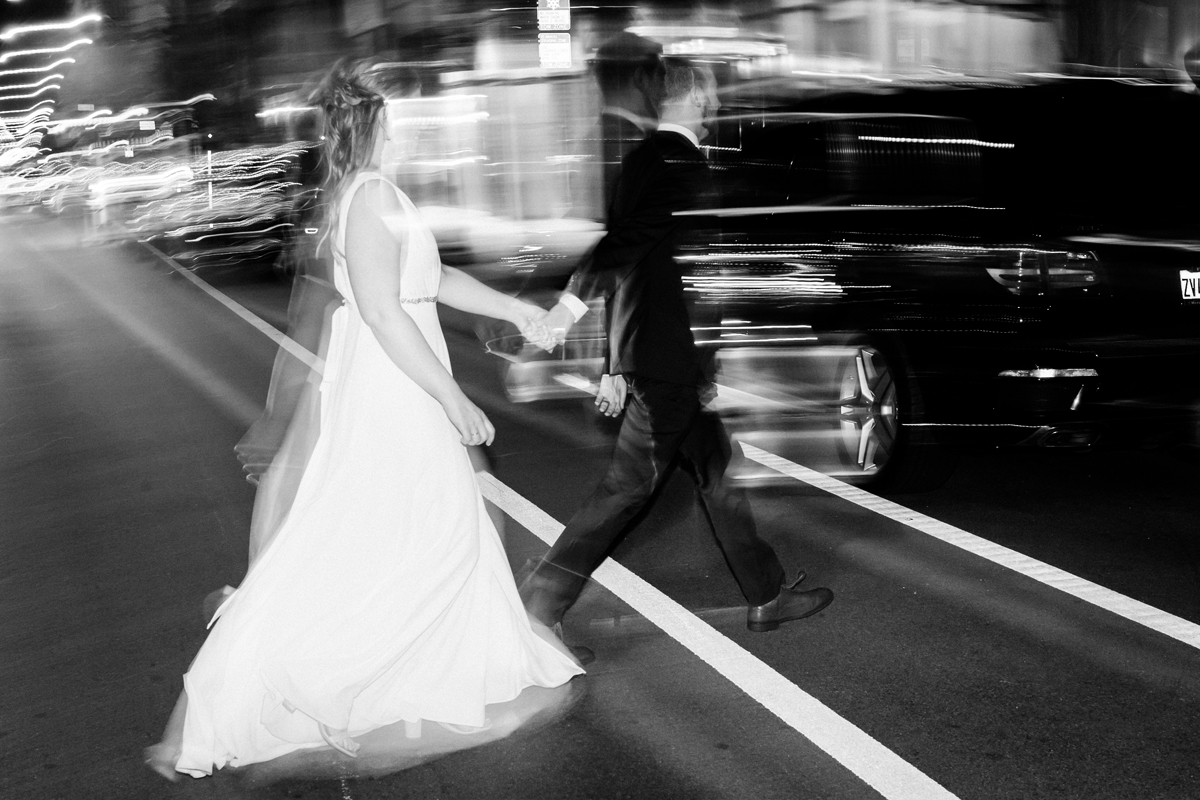 Bride and groom walk across Halsted in Chicago.