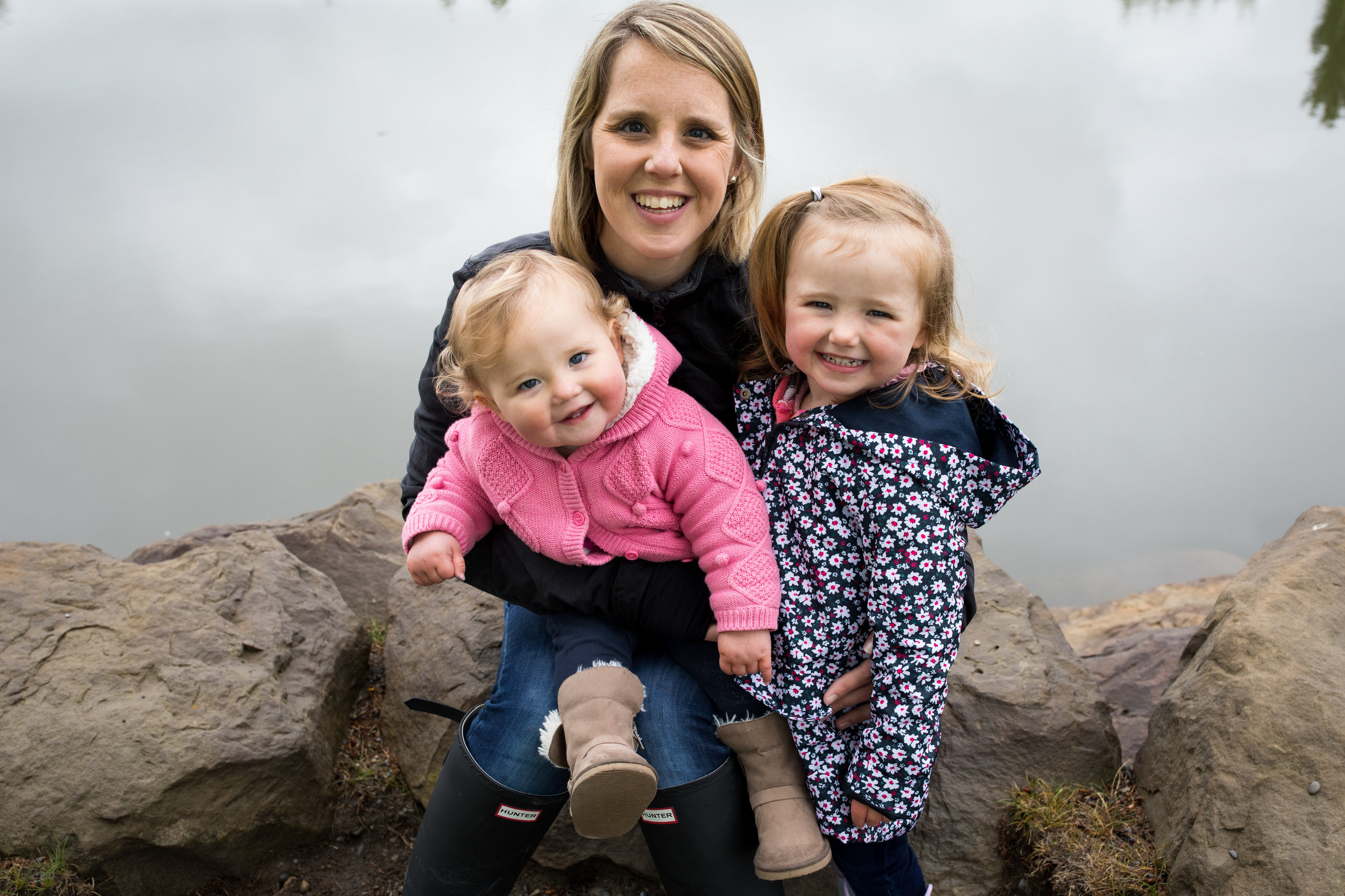 mom and daughters posing