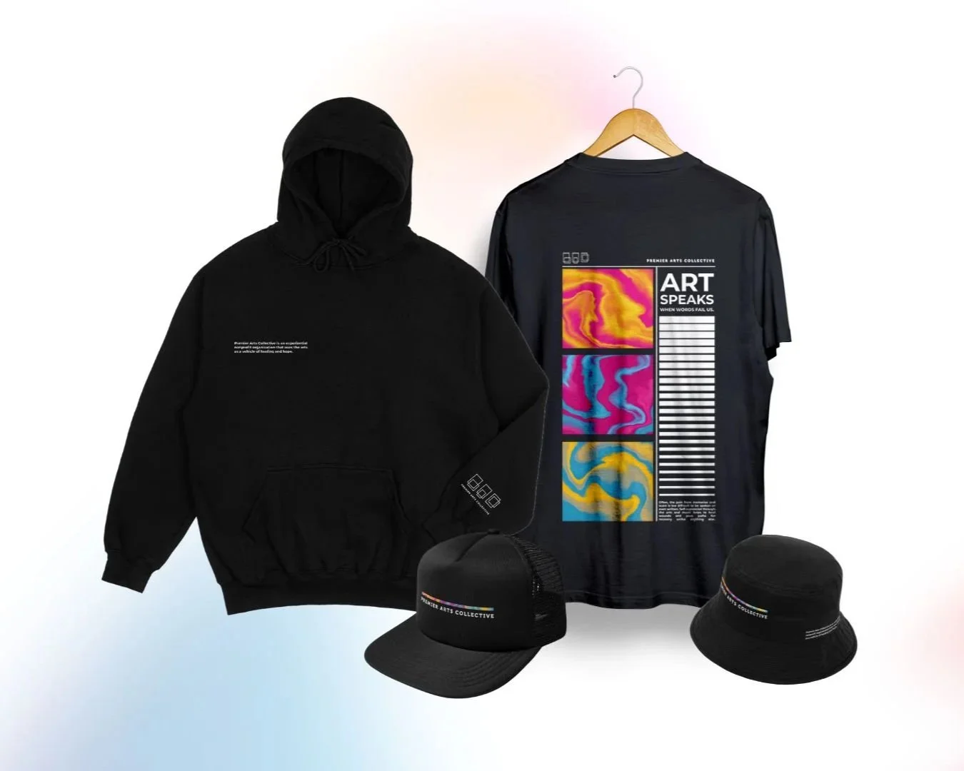 Black hoodie with small white text on the chest, a black graphic cap, a black bucket hat, and a black t-shirt with colorful abstract art designs and text that reads "ART SPEAKS" and "PREMIER ARTS COLLECTIVE".
