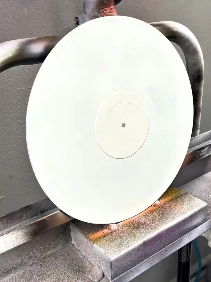 Painting vinyl records. My local music shop gives them out for free (low value, scratched, etc).

Have also been experimenting with using candy flake and holographic paints (the sparkly/shiny paints you usually see on custom cars). I am one step clos