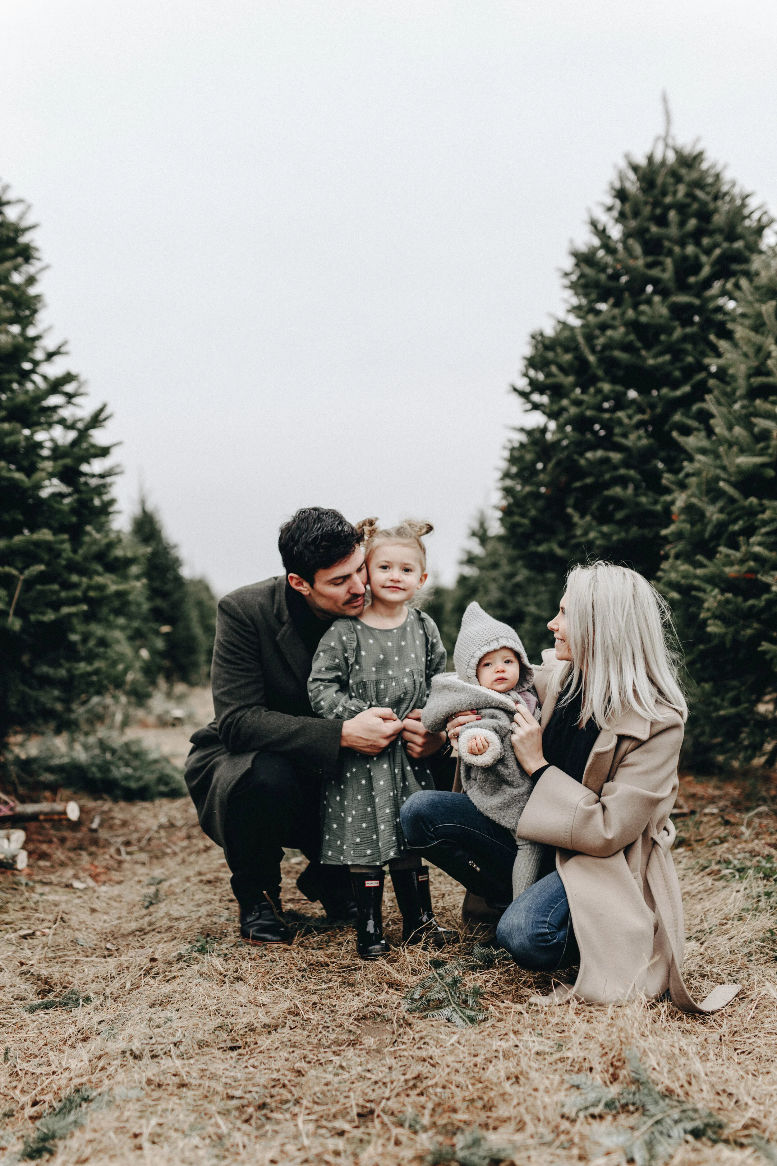 the price family during a christmas photoshoot on a tree farm