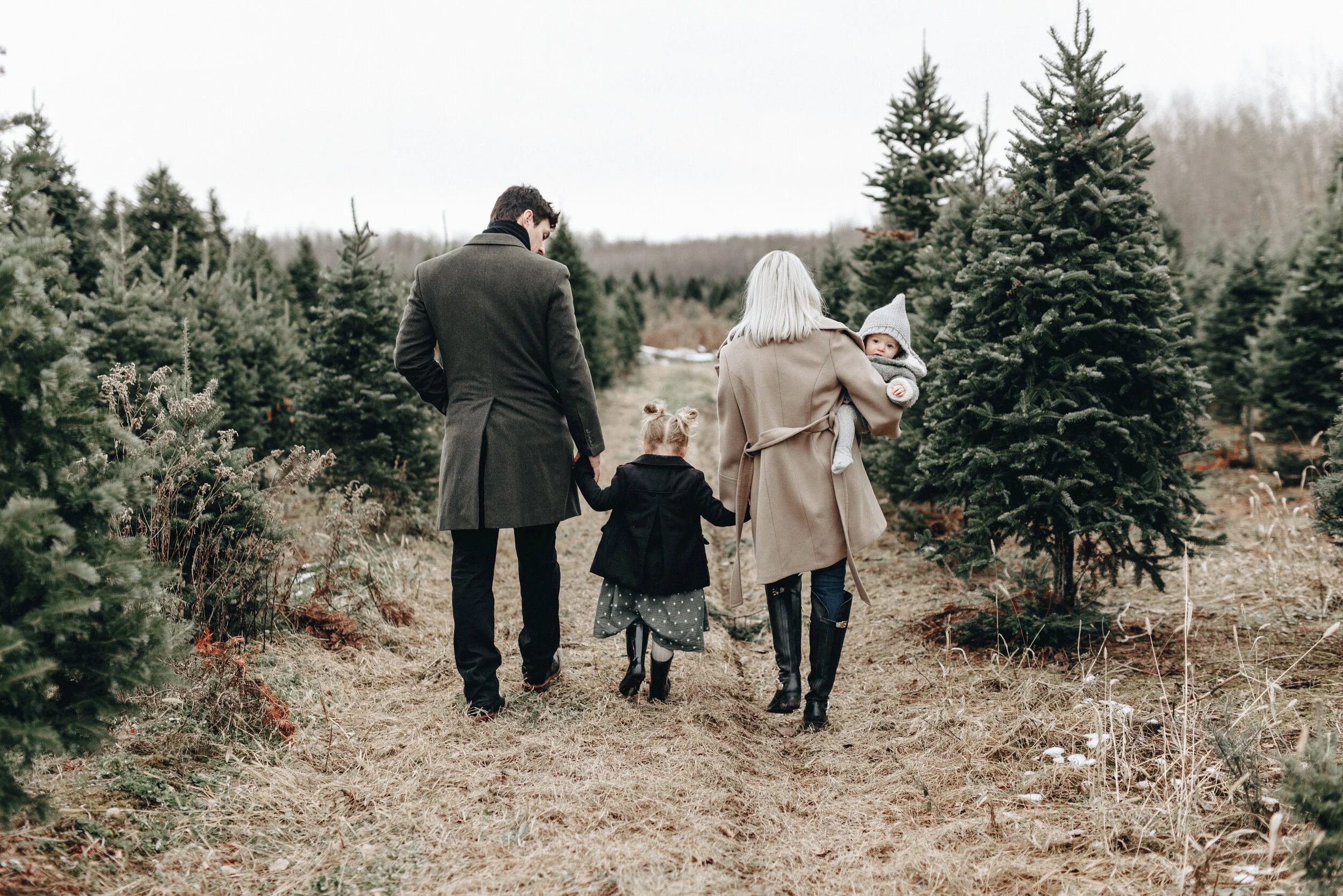 the price family walking through a christmas tree farm