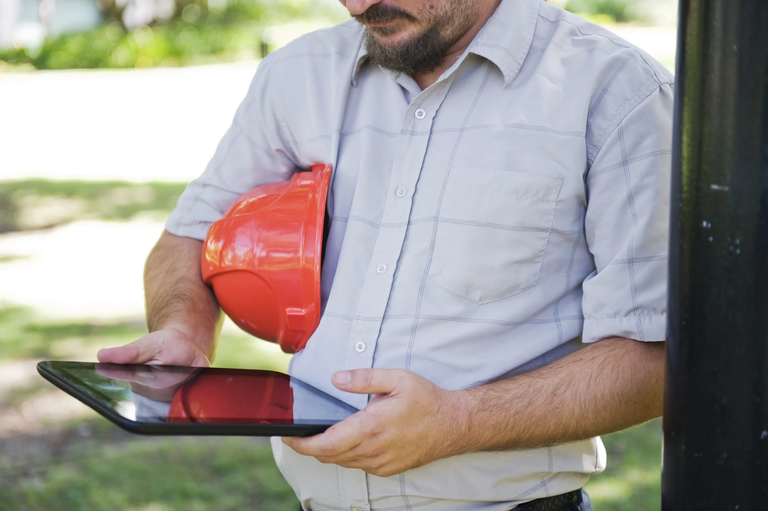 Inspector Mick half body holds tablet.jpg