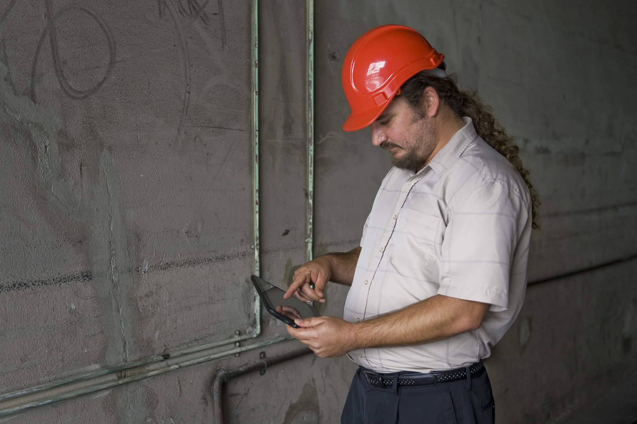 Inspector Mick holds tablet.jpg