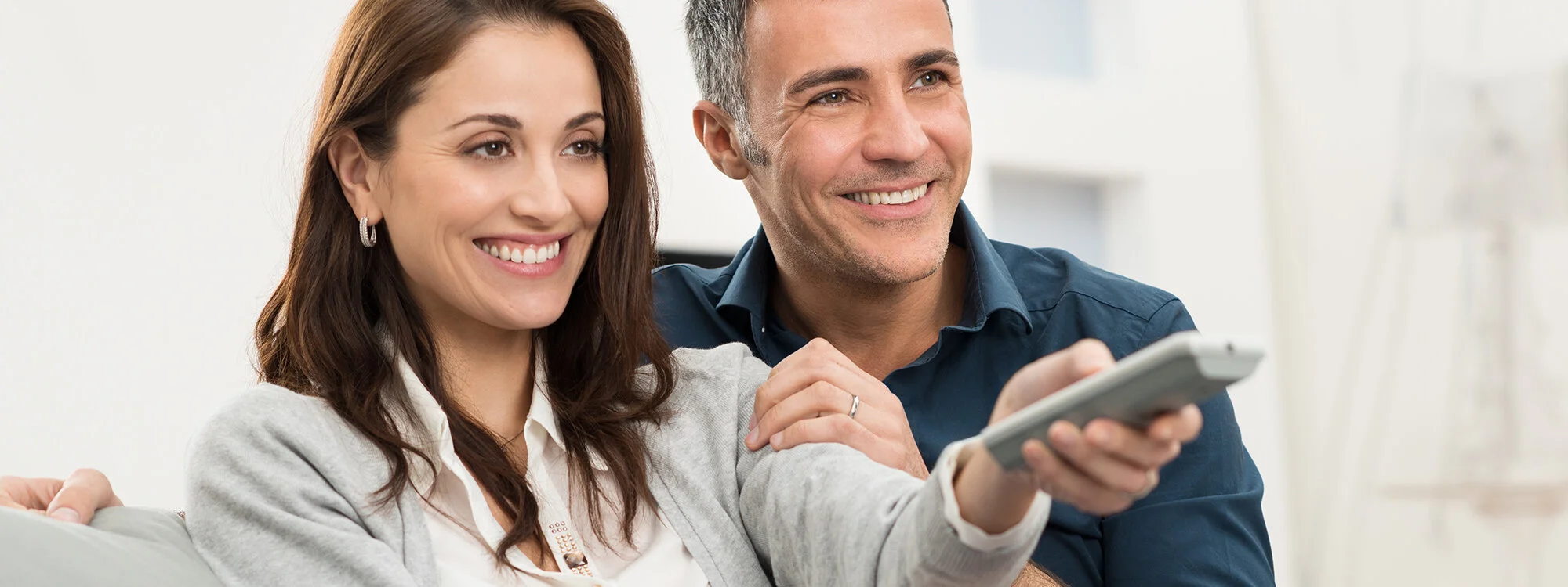 bigstock-Happy-Smiling-Couple-Watching--59731427.jpg