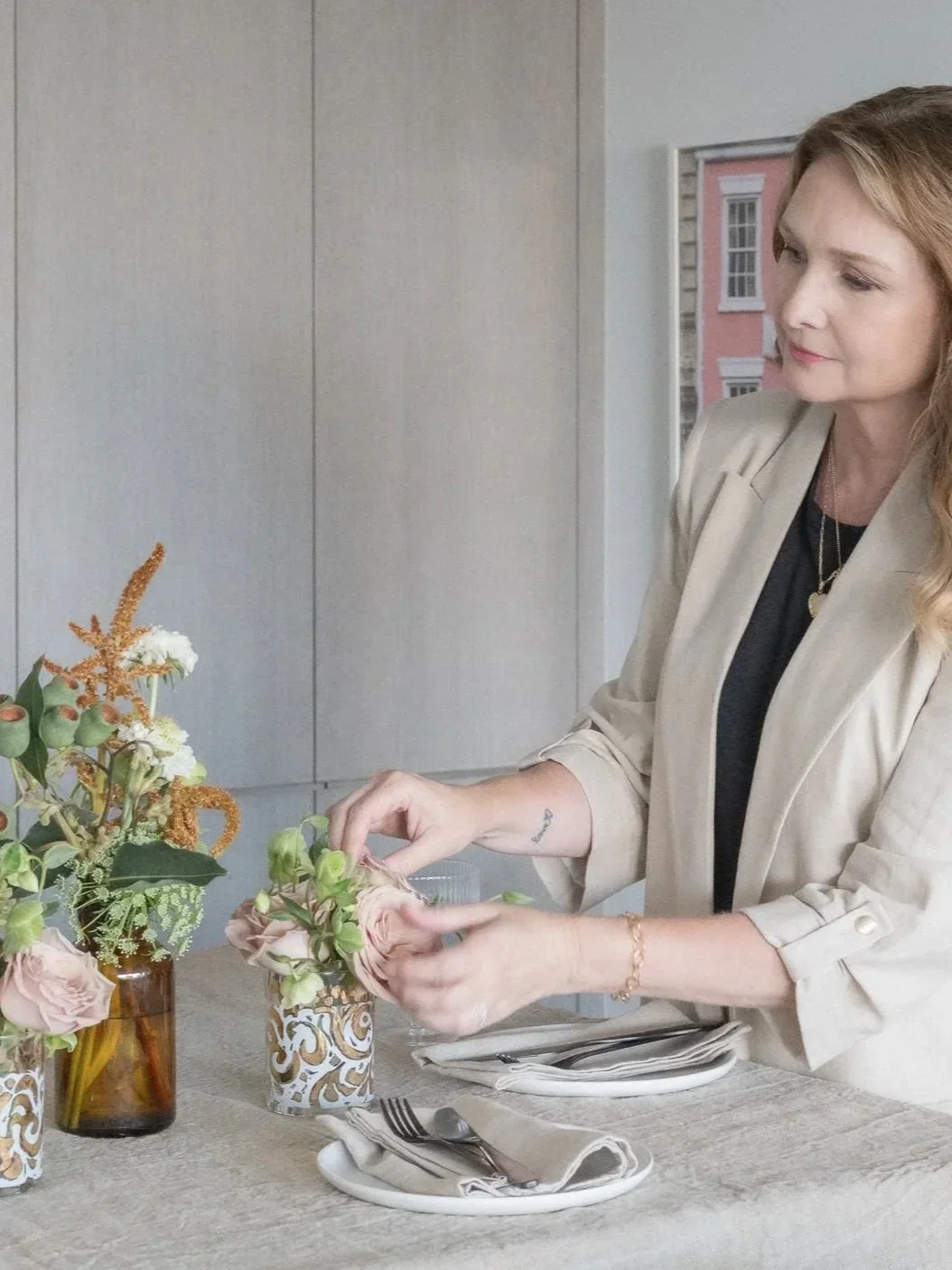 Karla Dreyer arranging lavender roses on a table.
