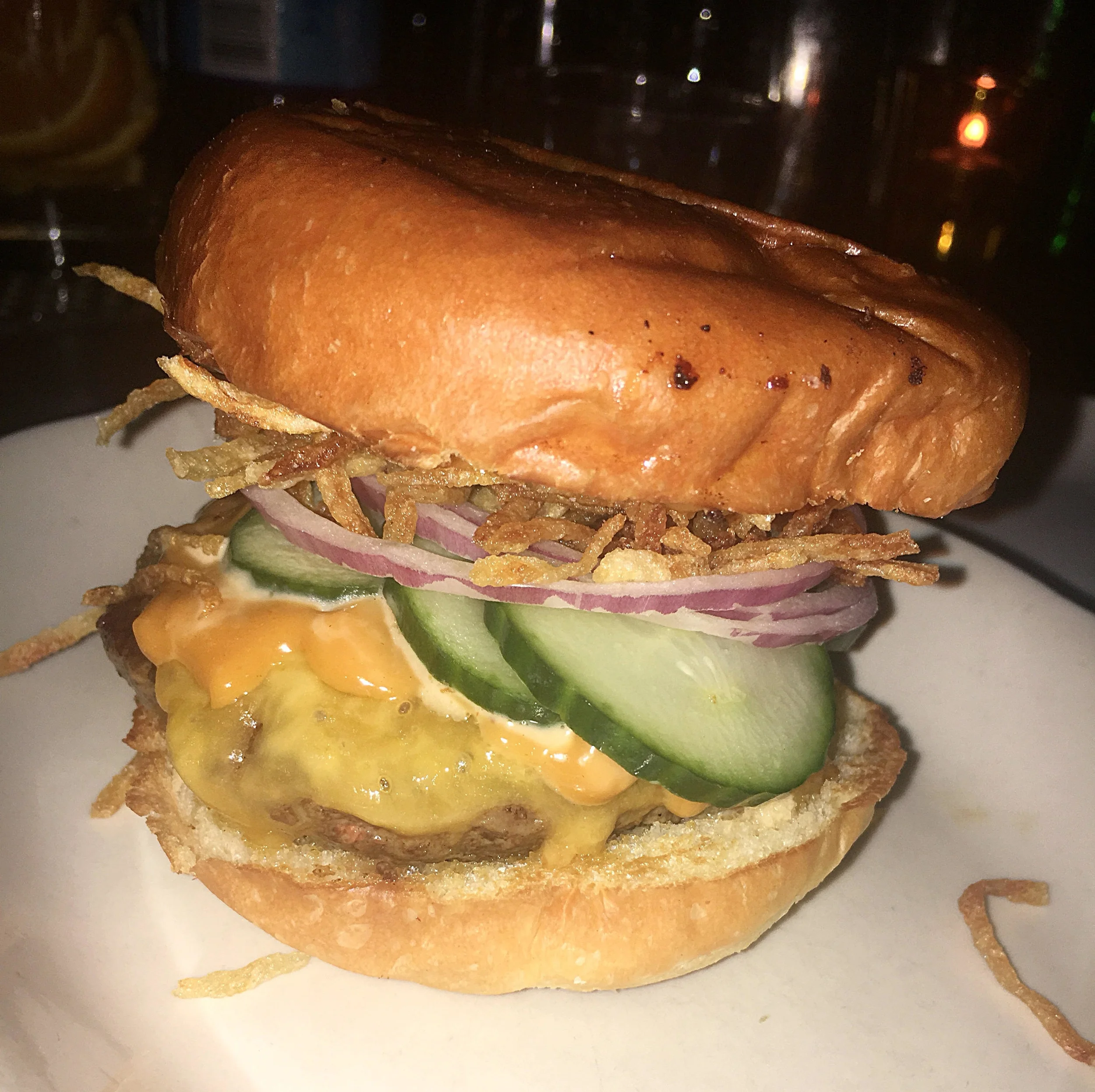 Fedora burger: smoked cheddar, crispy potatoes, cucumbers, BBQ mayo