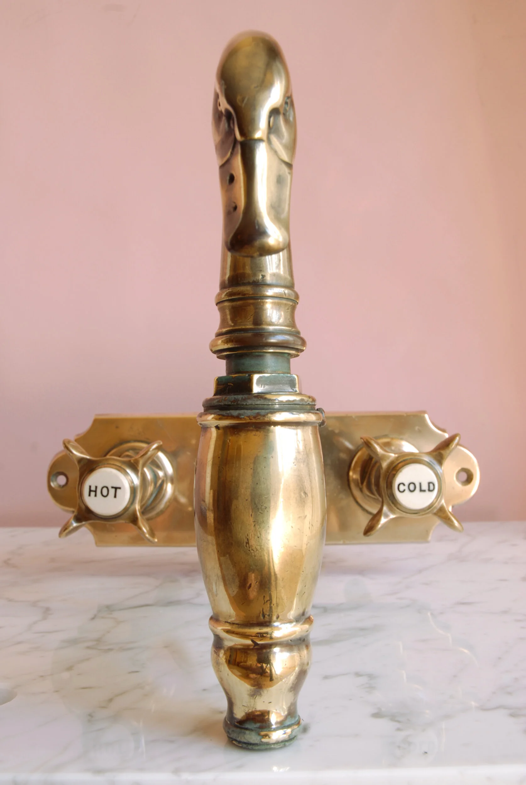 SIZED 426 Swan Neck Taps Front View Pink Background.JPG