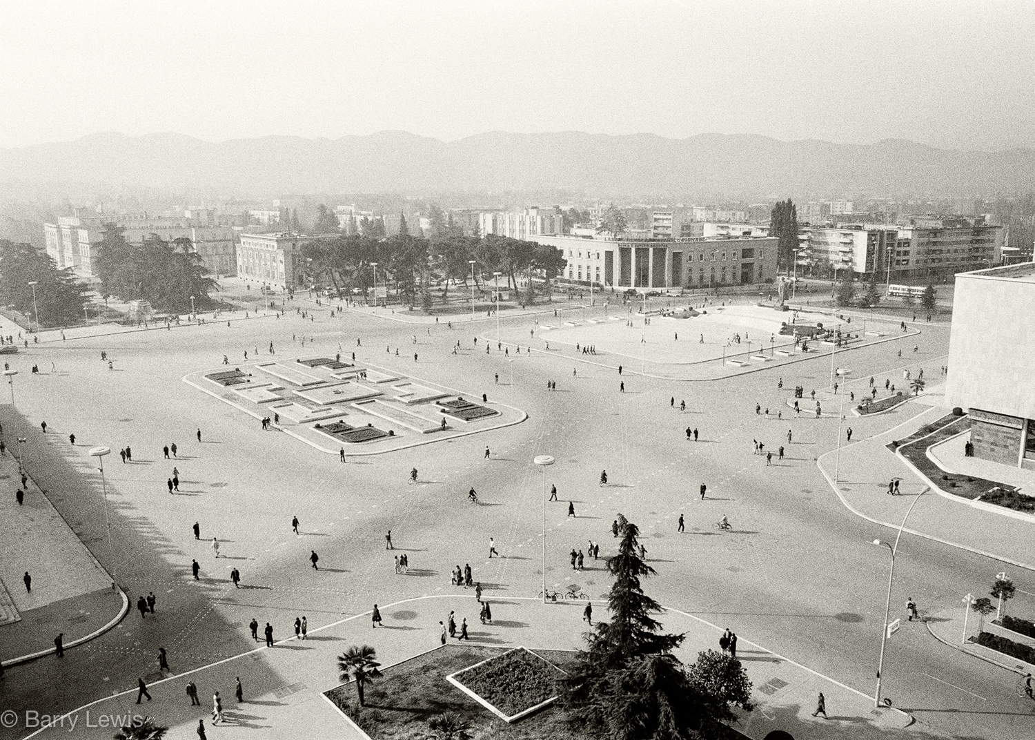  8am rush hour in Skanderbeg Square, Tirana, 1989
The quiet serenity of this busy scene is because prior to 1991, it was illegal to own a private car in Albania.The city is now choked with  cars, lorries and buses which burn fuel banned in the EU. Ti