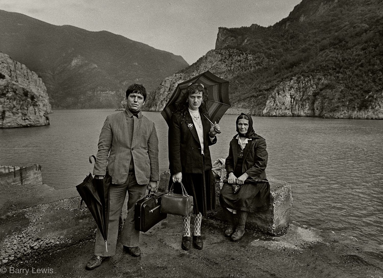  Albania family in their Sunday best waiting for the Koman Ferry to Bajram Curri, 1990. The ferry was the easiest way into the Highlands avoiding the bad roads. but cancellations and long delays were frequent. 