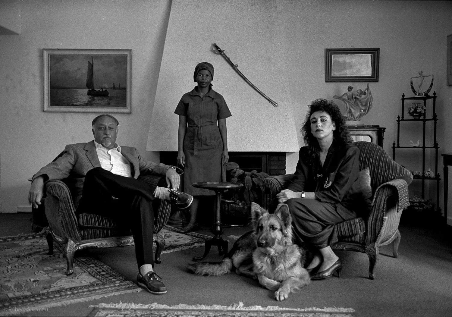 Pretoria, SA, 1991: Father, daughter and their dog who where planning on leaving SA with the advent of majority rule. They posed with the family's long time "servant" who would not be leaving.