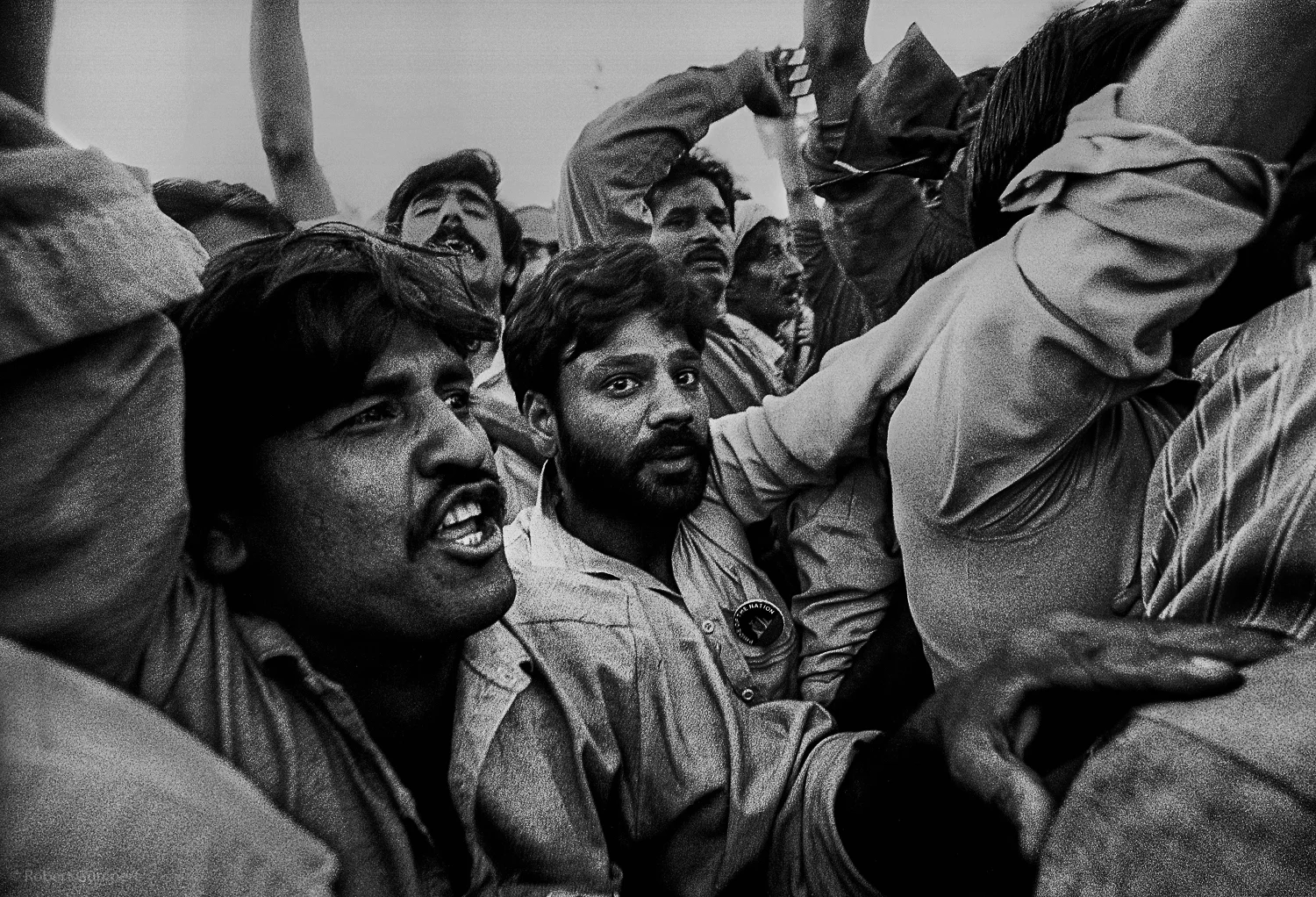 Lahore, Pakistan 1990: Supporters of a candidate greet him as he arrives in a car carvan.