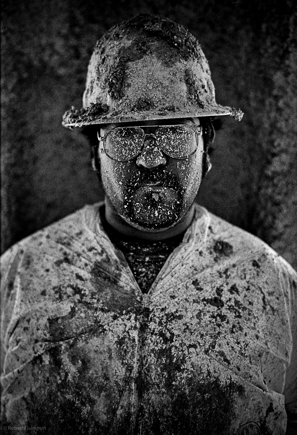 San Francisco, CA. 2000. Apprentice contruction worker covered in insulation material.