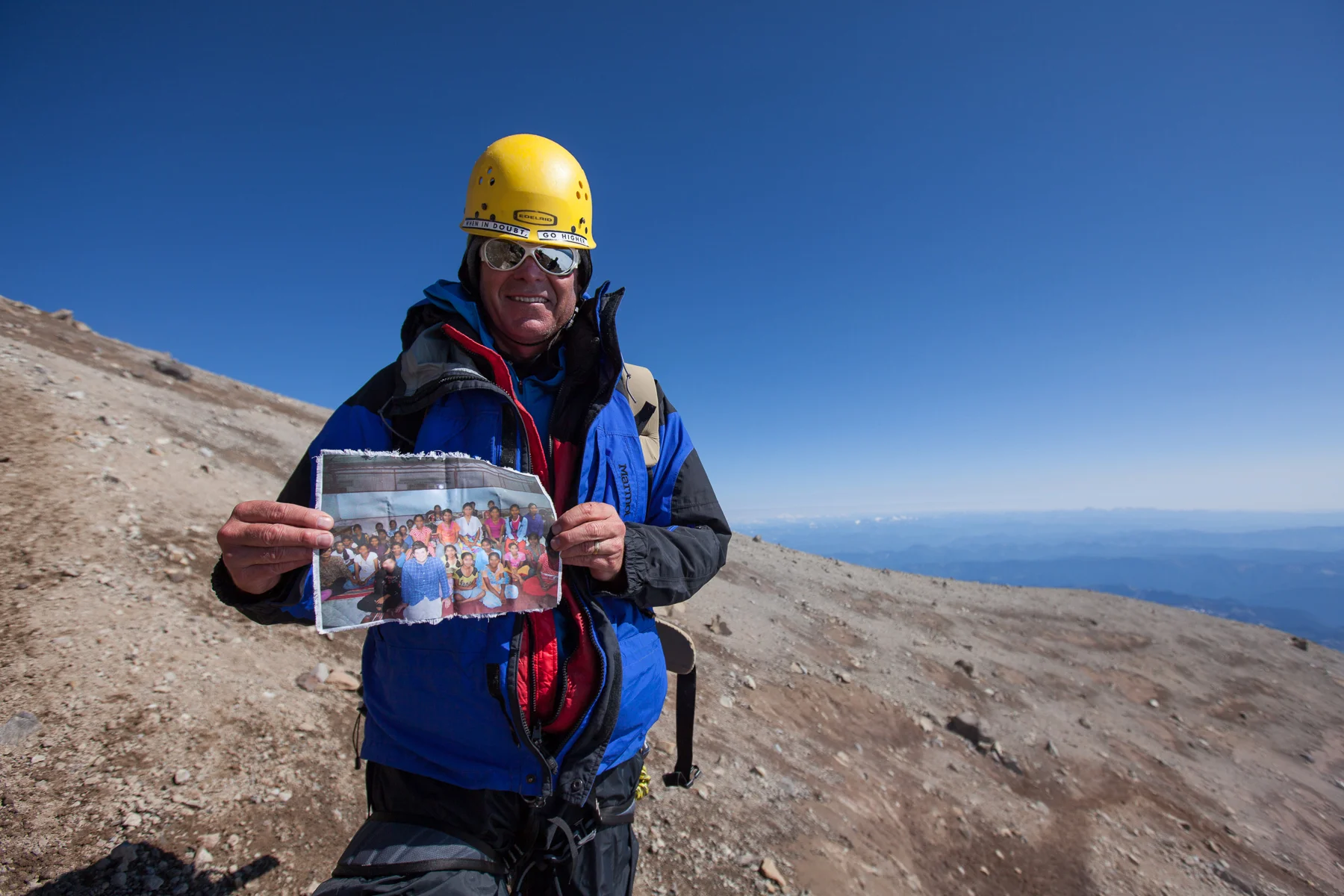 C4C climber holds a photo on the summit of Rainier. These were the girls in India who were actively praying for us as we climbed for them in 2013. He had met them in India that year, so the climb was particularly personal for him. Sound bites from the girls are often played over our walkie talkies from our base camp crew while we are on the mountain. It. Is. Intense.