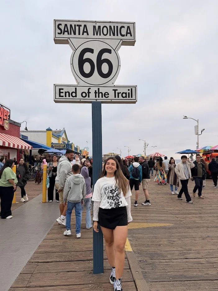 Student at the Santa Monica Route 66 End of the Trail sign