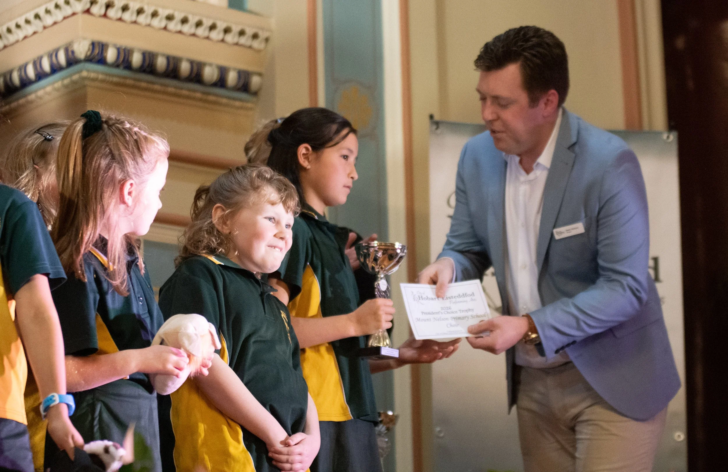 Mt Nelson Primary School Choir receiving their President's Choice Trophy from President, Mark Holmes.