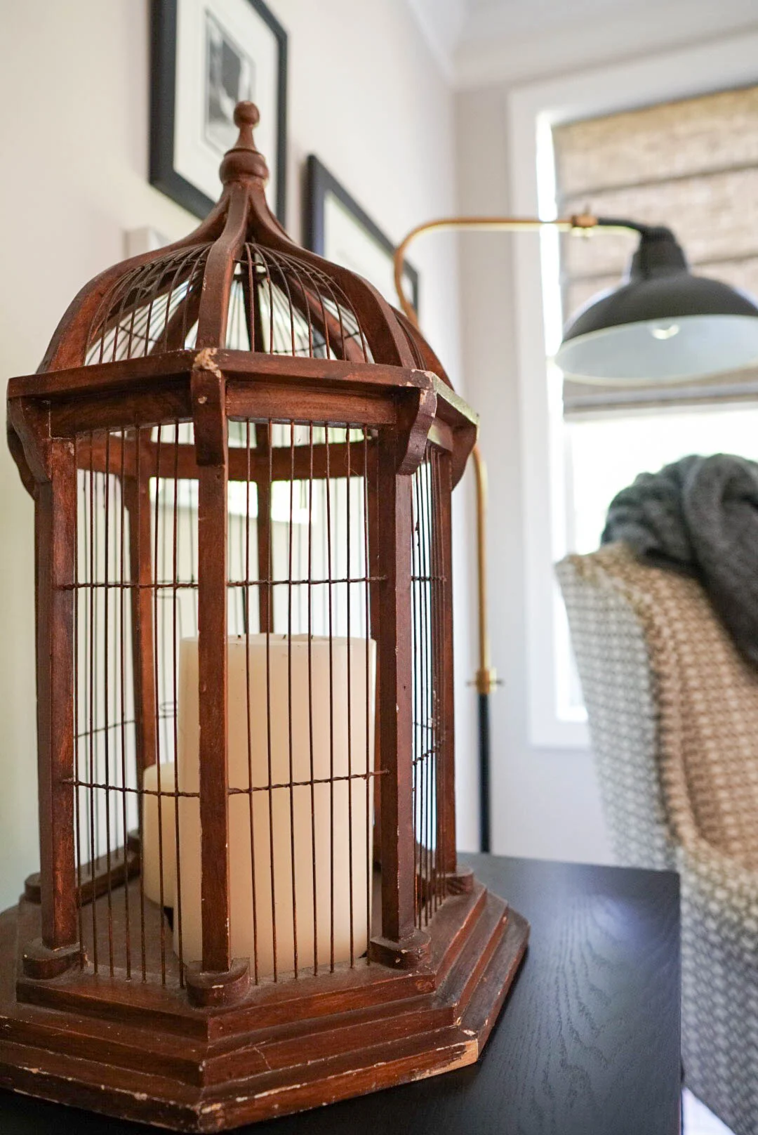 Vintage birdcage adds balance, texture and interest on our media console. 