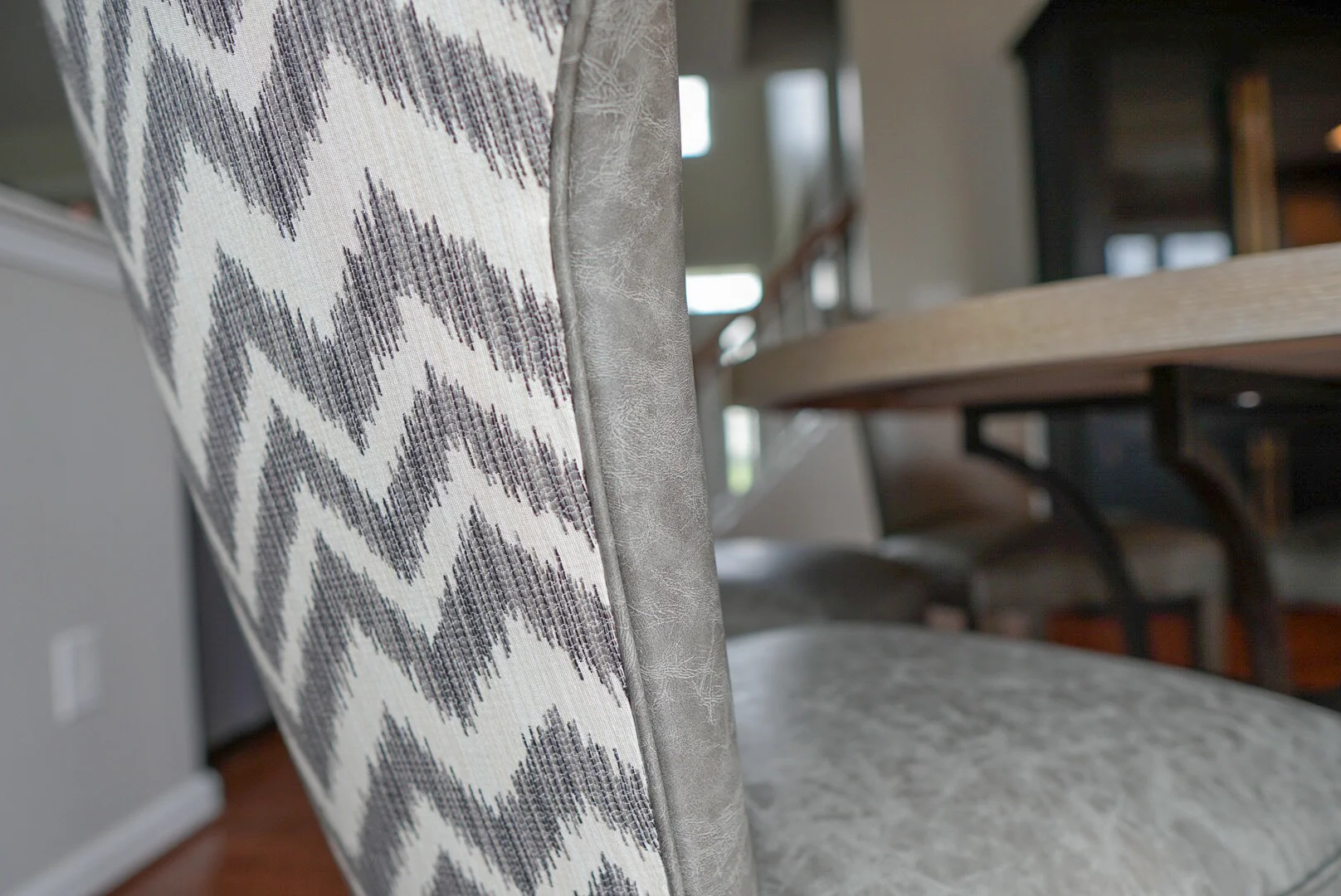 AFTER: Kitchen table chairs featuring a gray vinyl interior and chevron printed back
