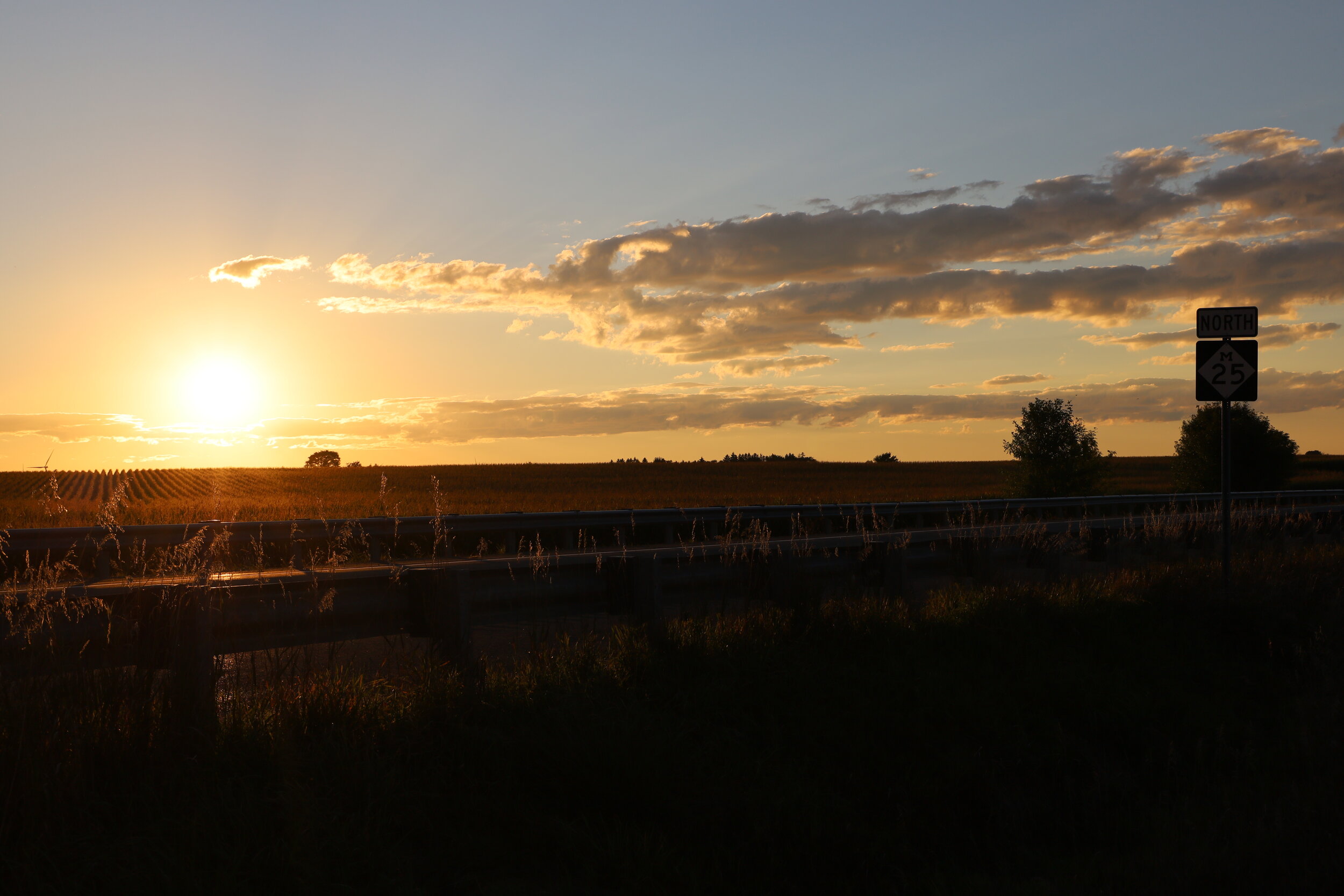 North M-25 darker - sunset, farm field, wind turbine, sky.JPG