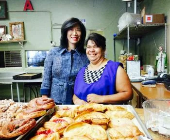 Grameen America President & CEO Andrea Jung with Bertha, a baker in Los Angeles who is growing her business thanks to a microloan from Grameen America.