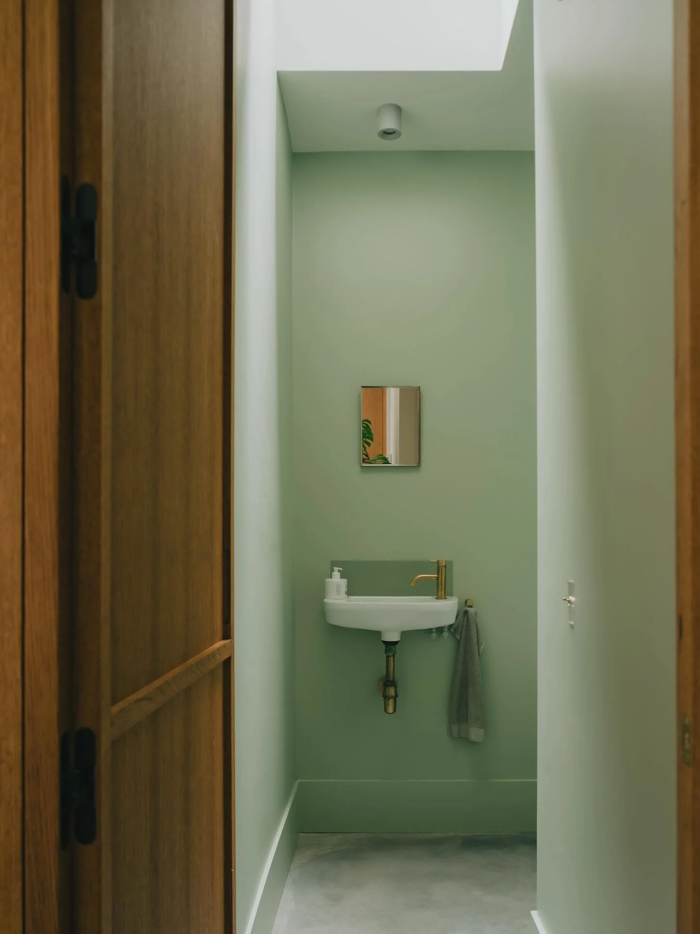 A sleepy shot of the downstairs bathroom at the Hideaway House. The inward opening doors were one of the trickiest elements in the project to resolve. We wanted them to look and feel exactly like the kitchen cabinet doors, but with the knowledge that