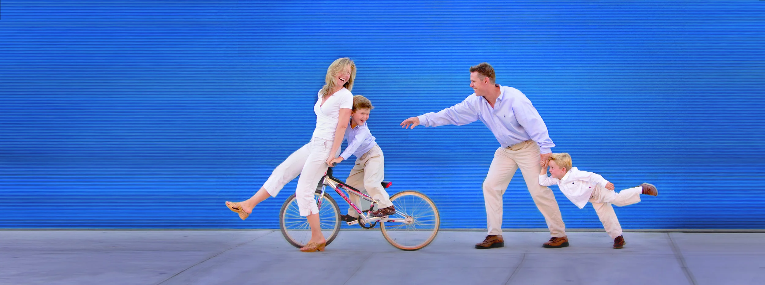 Fam on blue wall w bike.jpg