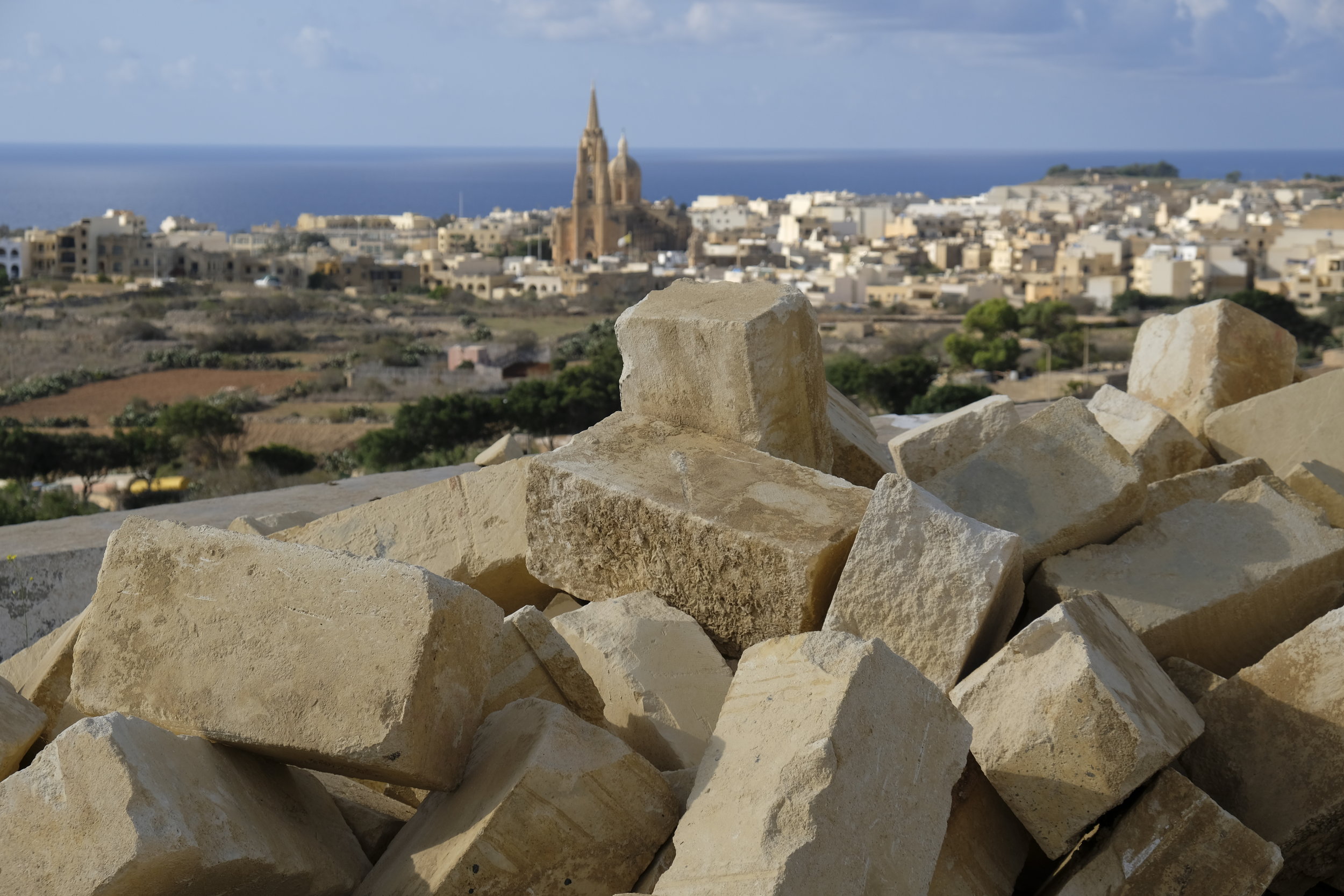 A view from the valley, with the sea to Malta in the background