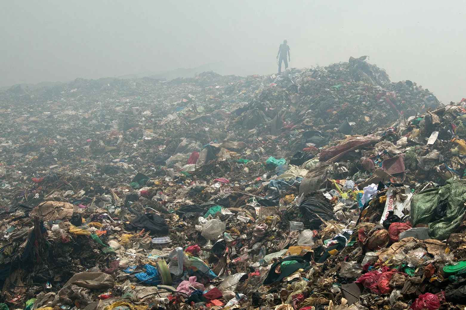 A waste picker at the Mbeubeuss landfill. He belongs to over 2000 people who search the waste for recyclable material and then sell it. The open landfill is one of the largest in the world, with around 2000 tons being unloaded every day. Ein Abfallsucher auf der Mülldeponie Mbeubeuss. Er gehört zu über 2000 Personen, die den Abfall nach wiederverwertbarem Material durchsuchen, um es danach zu verkaufen. Die offene Mülldeponie gehört zu den grössten der Welt, rund 2000 Tonnen werden täglich dort abgeladen.