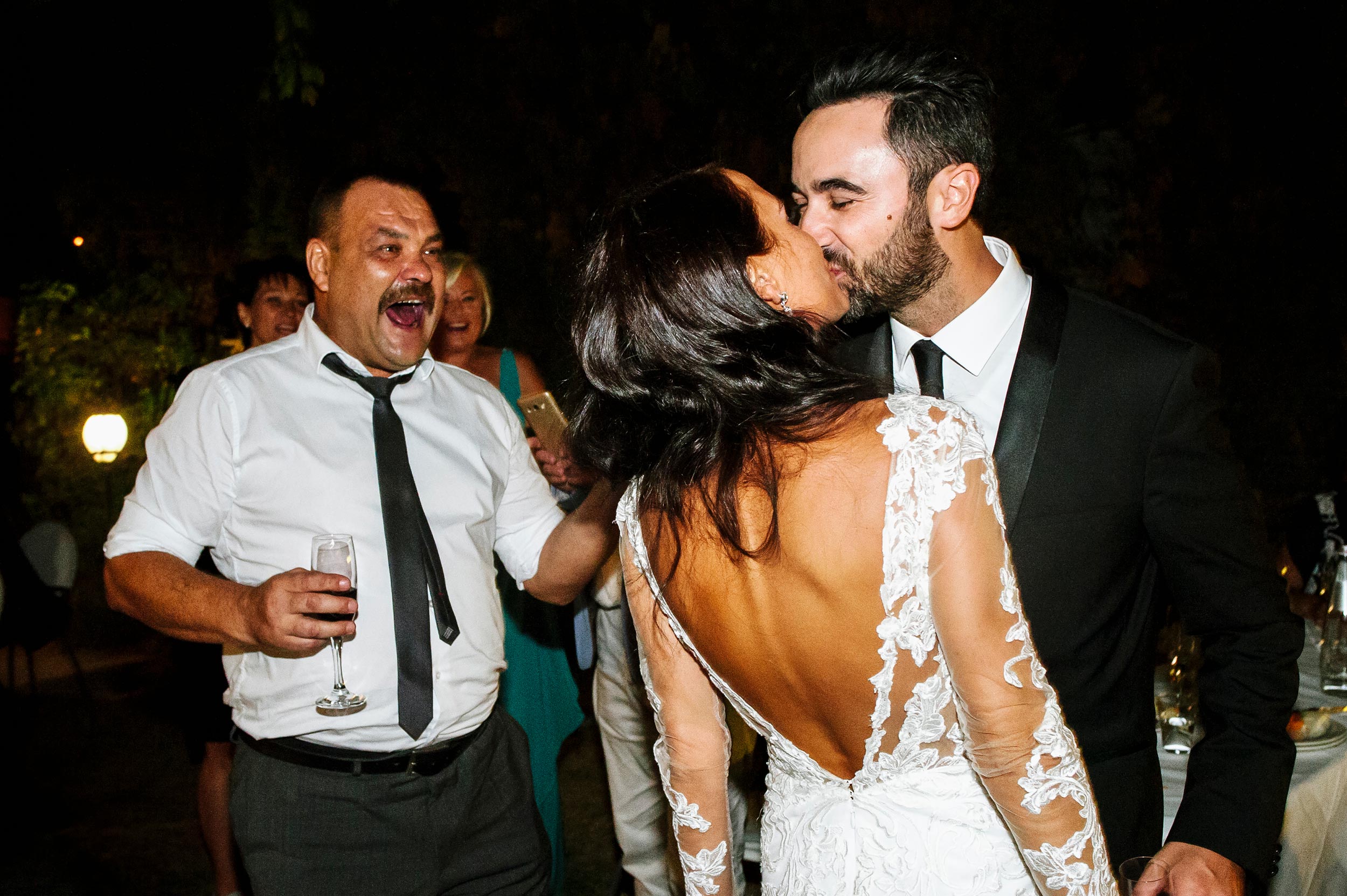 bride-and-groom-kissing-in-front-of-brides-father.jpg