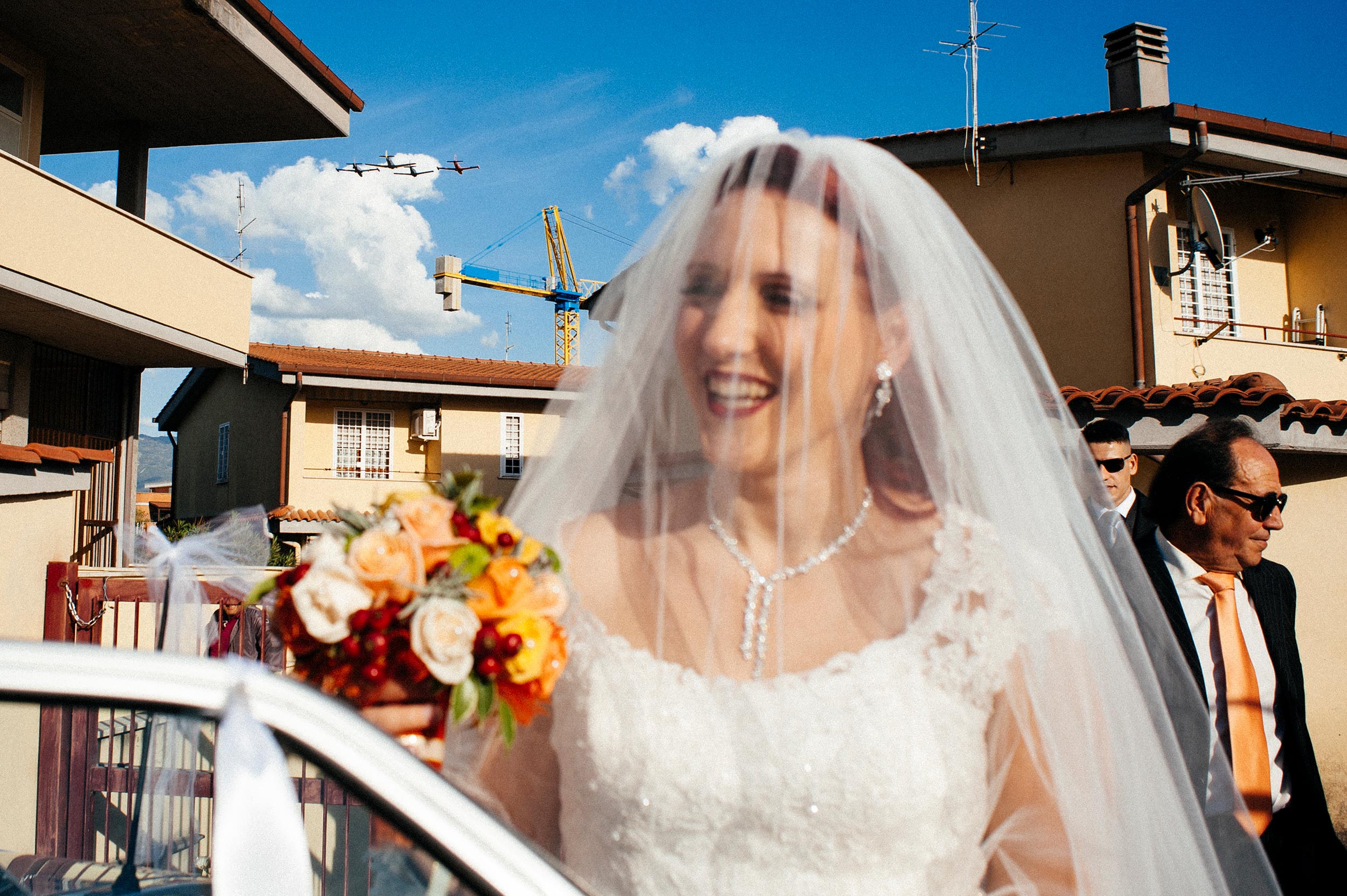 bride-going-to-ceremony-while-aircrafts-pass-over-her-head.jpg