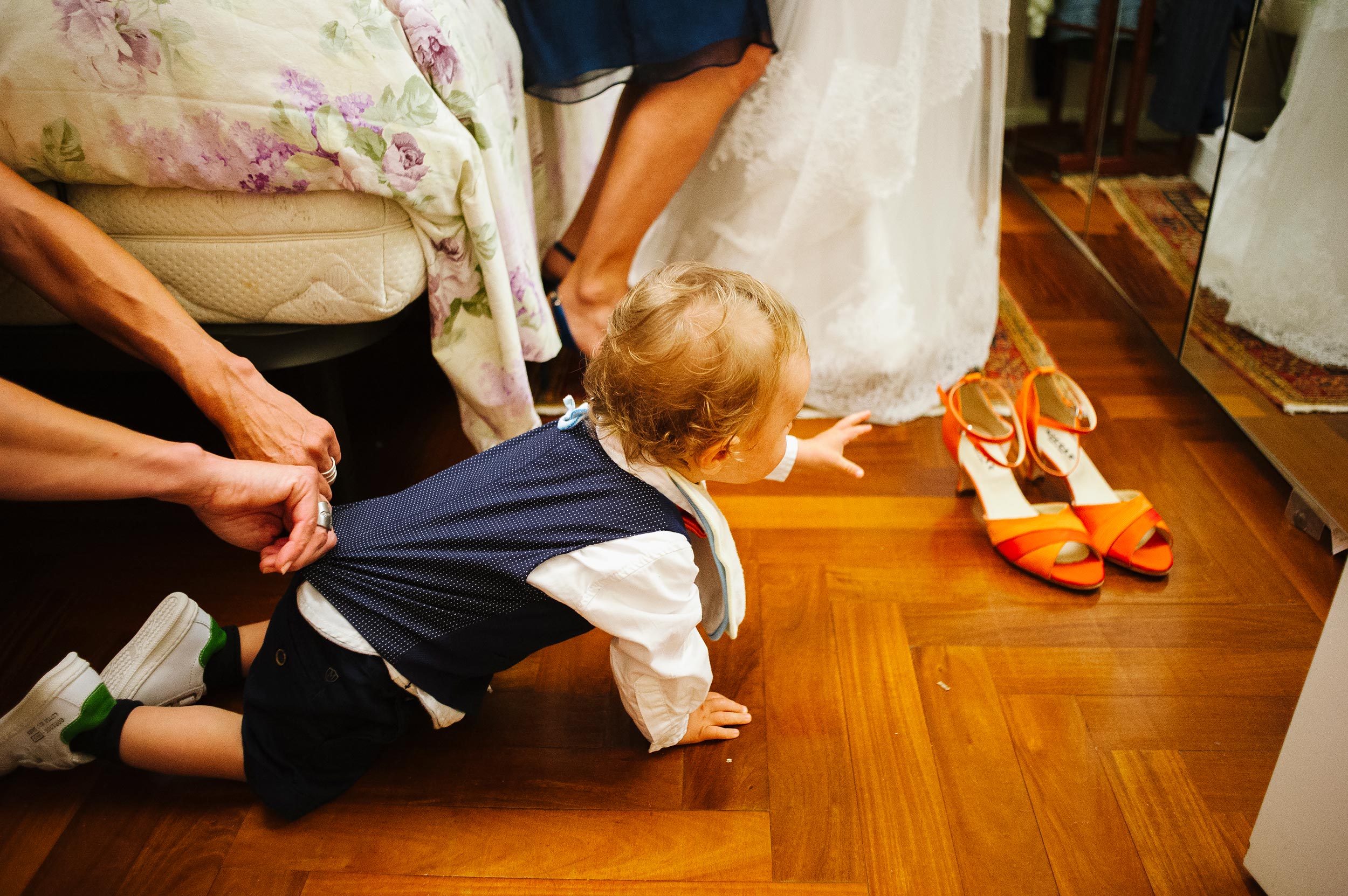 kid-aims-for-brides-shoes-while-his-mom-holds-him.jpg