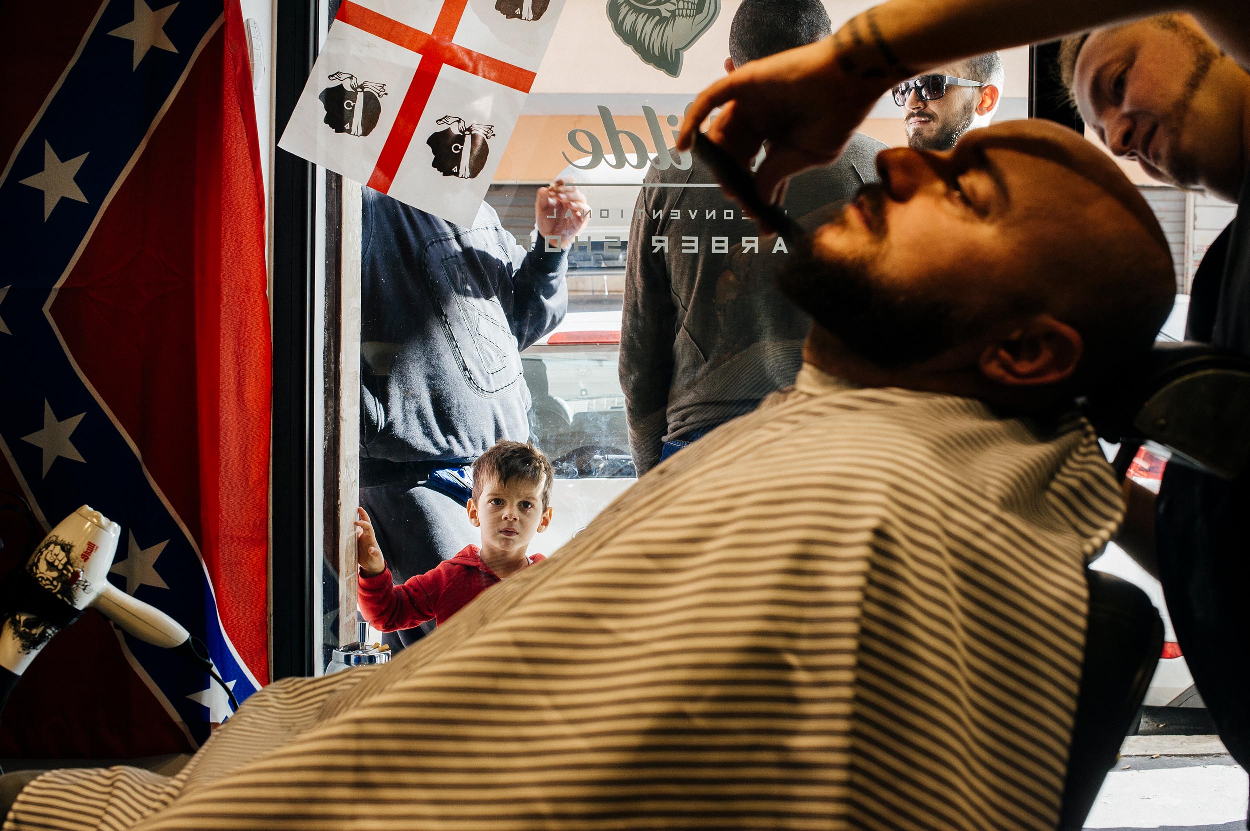 kid-watches-groom-in-the-barbershop.jpg