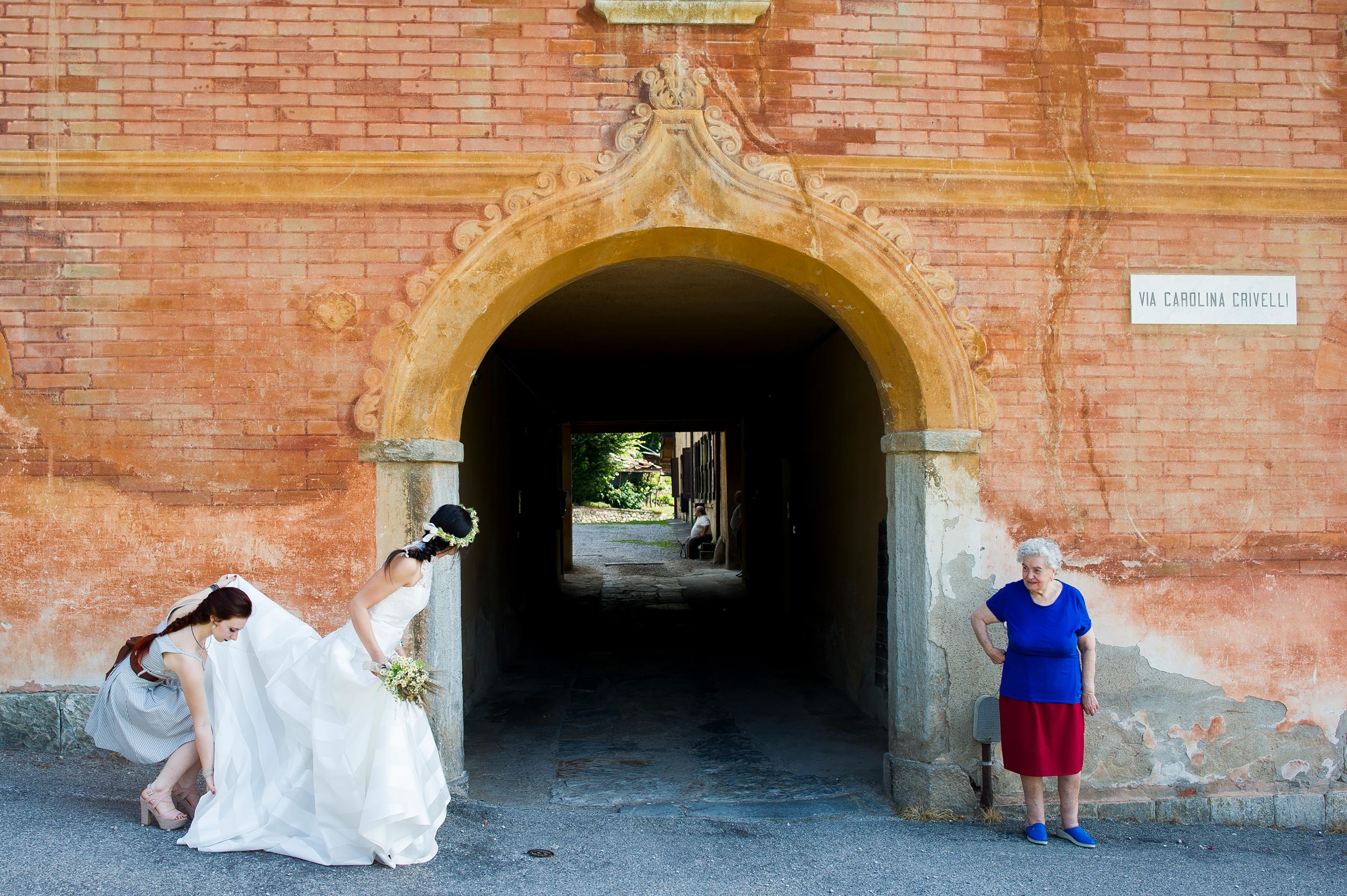 wedding-italy-the-bride-await-for-the-car-while-a-woman-stands-pattern-shapes-colors.jpg