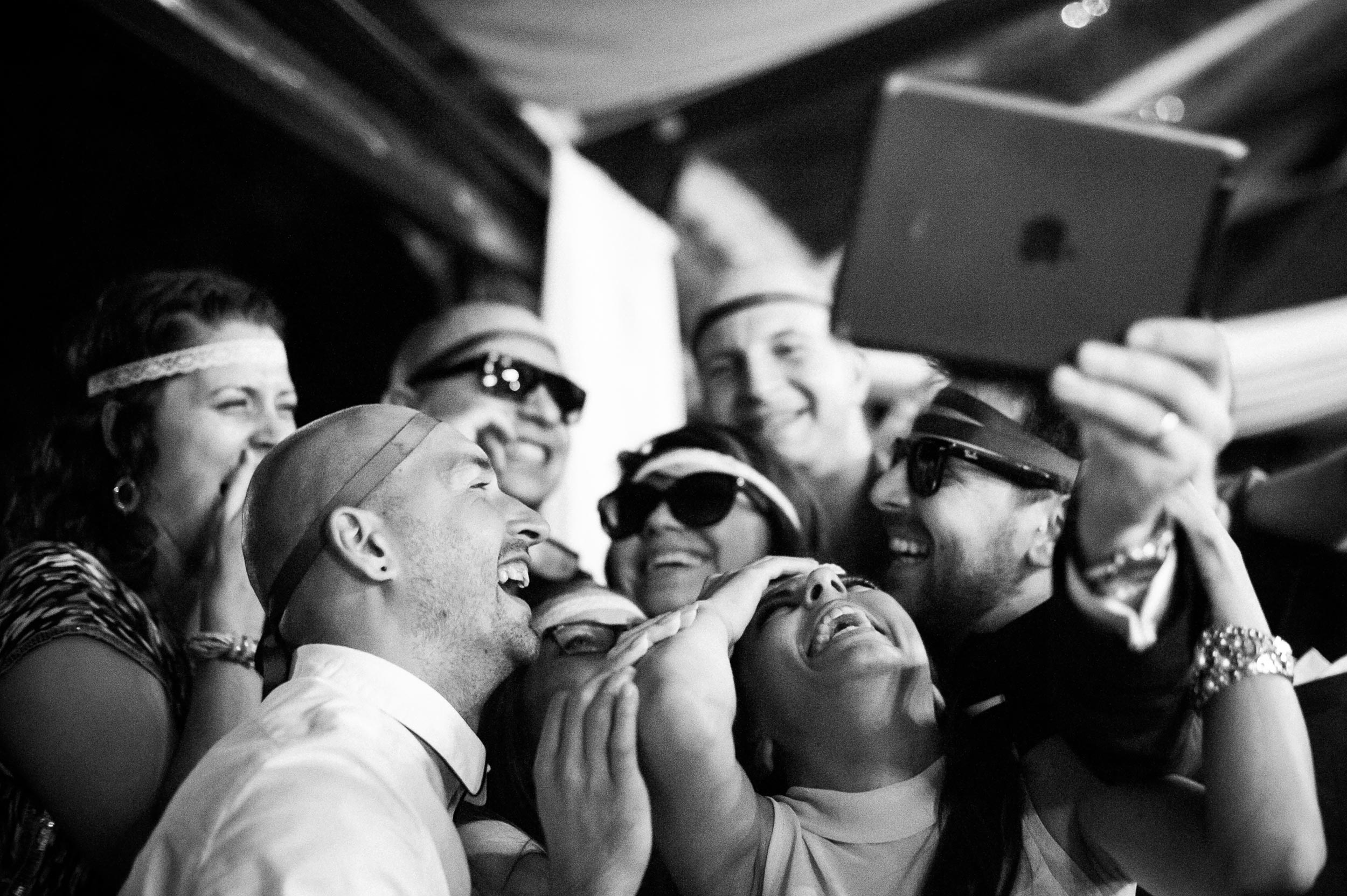 guests-having-fun-with-selfies-at-wedding-reception-in-rome-italy-black-and-white-wedding-photography.jpg