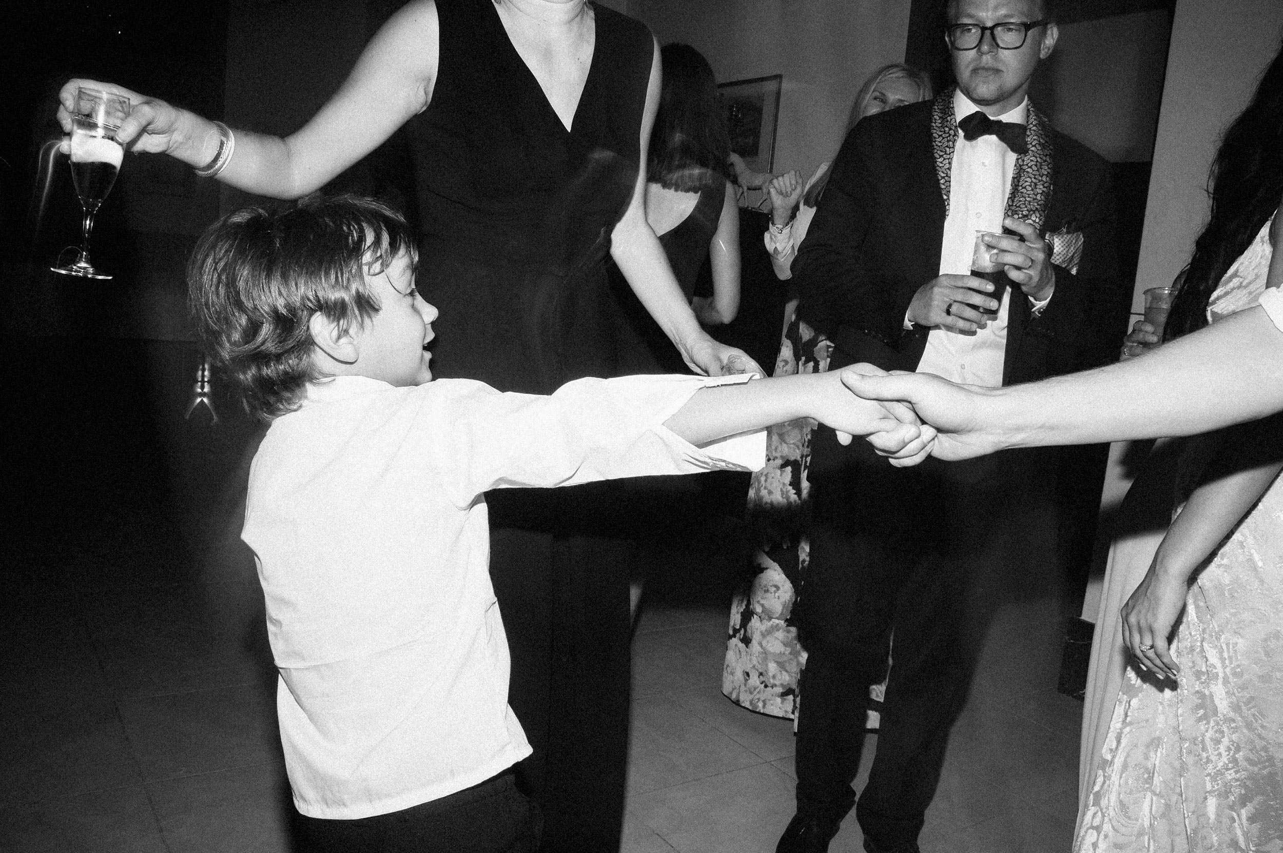 kid-dancing-during-reception-black-and-white-60s-style-black-and-white-wedding-photography.jpg