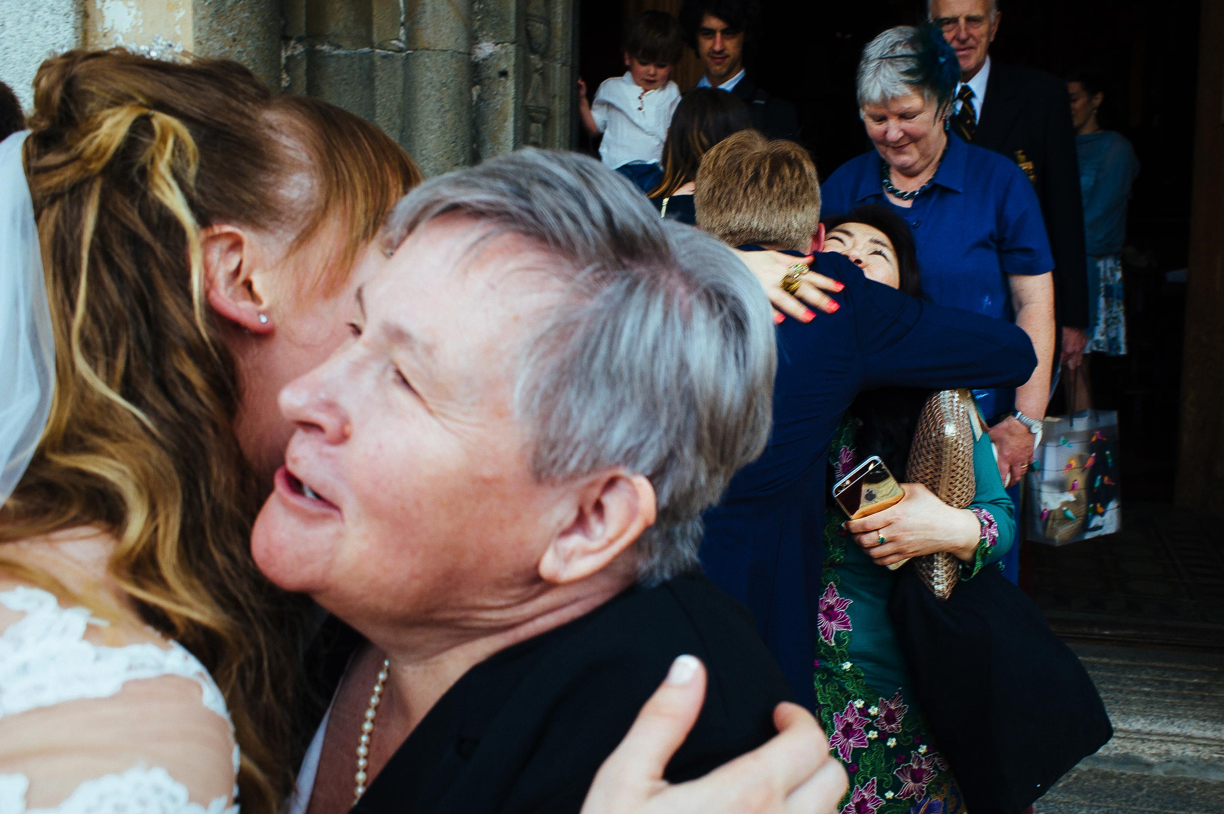 bride-and-groom-kissing-people-outside-the-church-wedding-lake-orta-italy.jpg