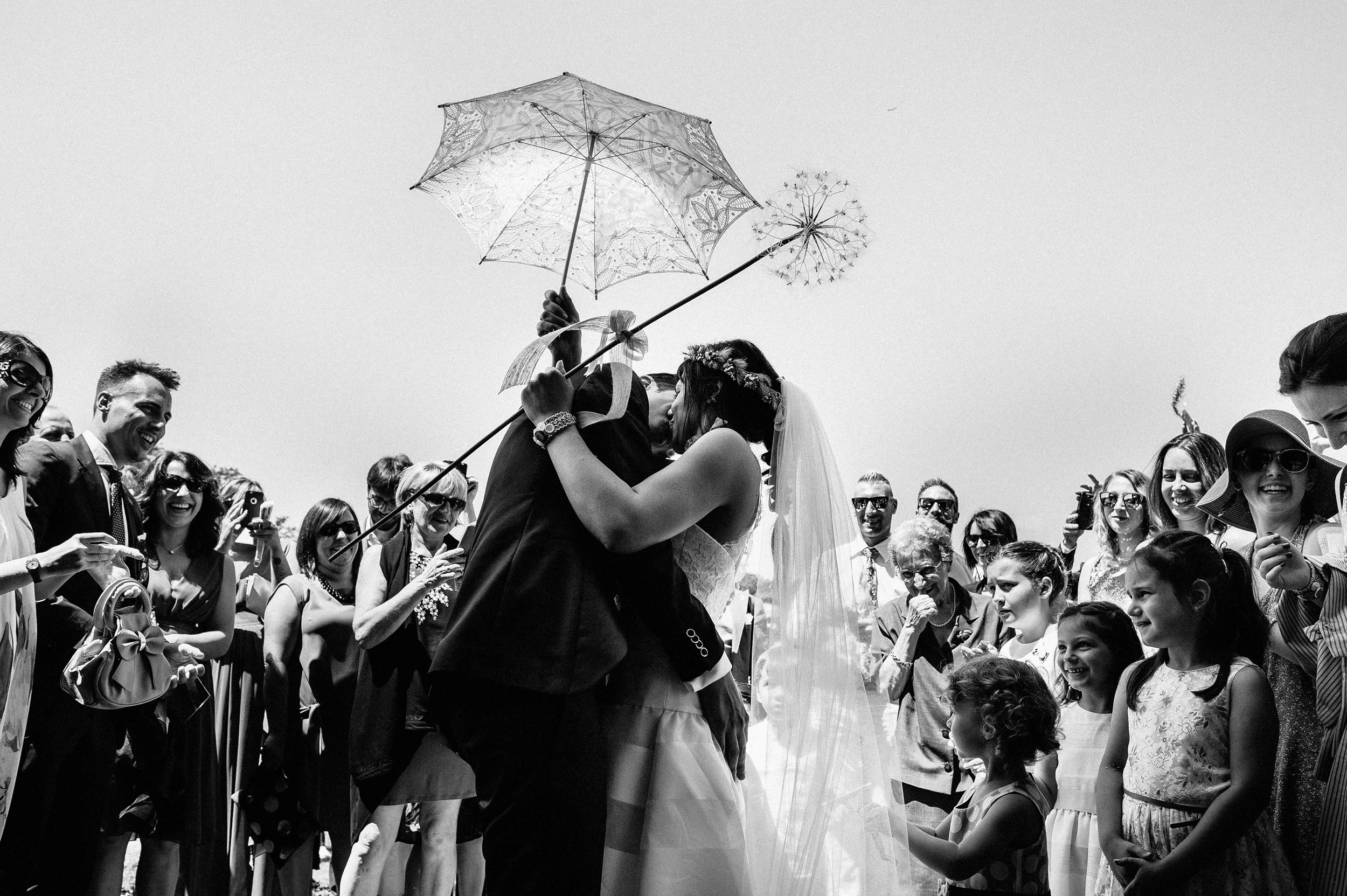 bride-and-groom-kissing-outside-the-church-black-and-white-wedding-photography.jpg