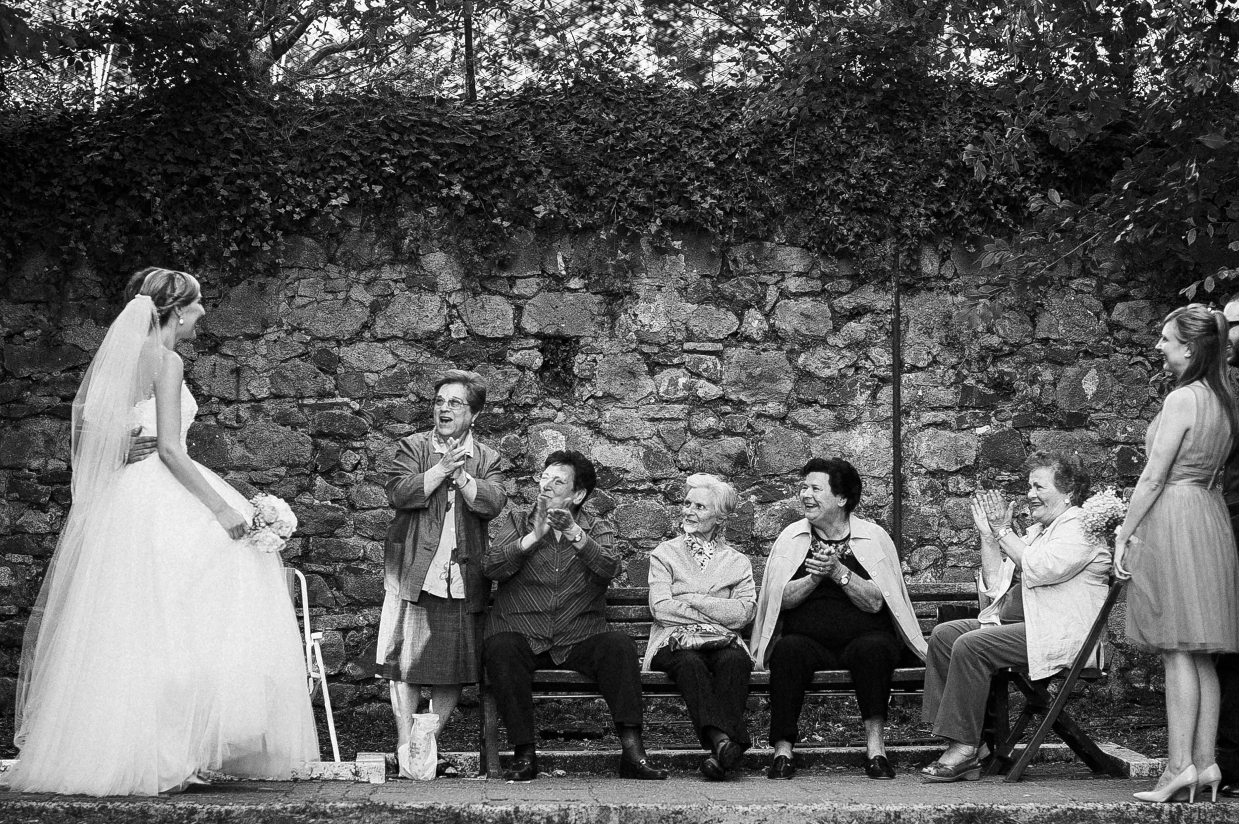 bride-and-groom-meet-old-ladies-wedding-in-italy-local-people-black-and-white-wedding-photography.jpg