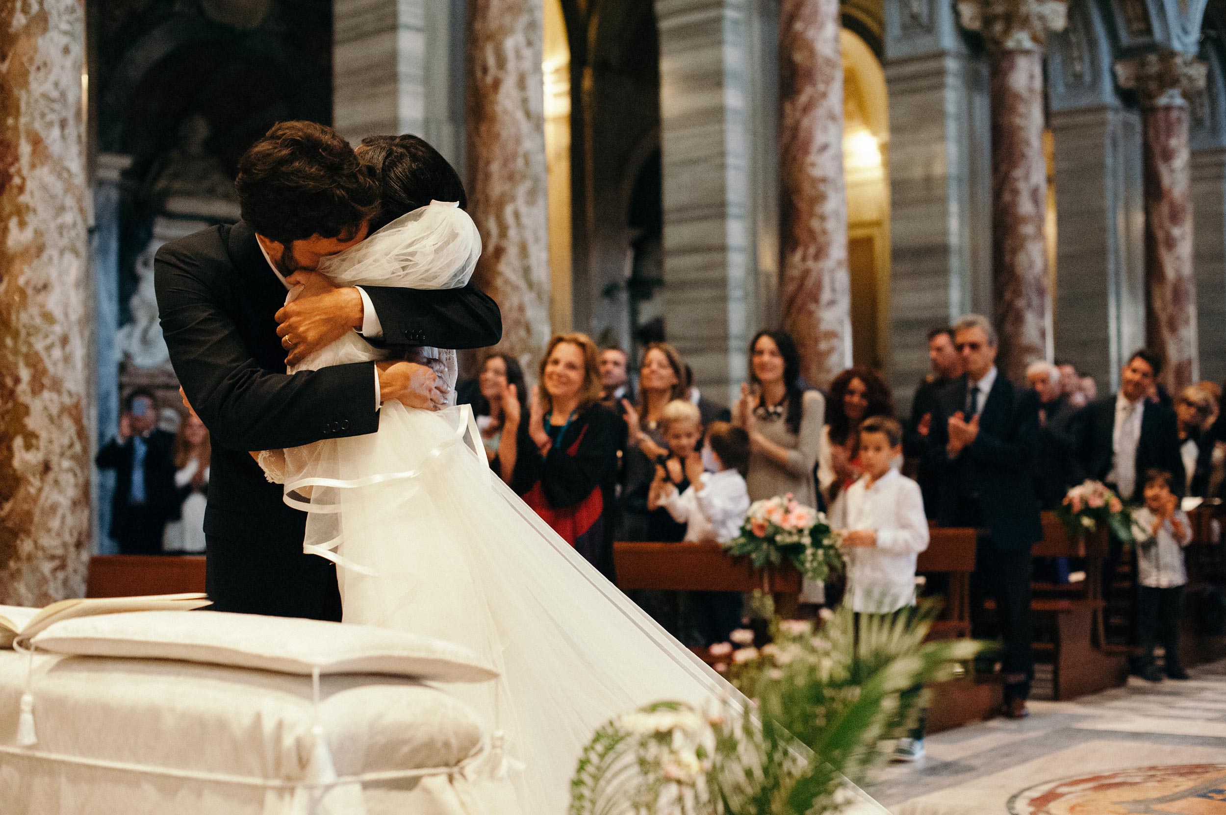 groom-hugs-the-bride-in-great-emotion-during-ceremony-wedding-in-rome-italy.jpg