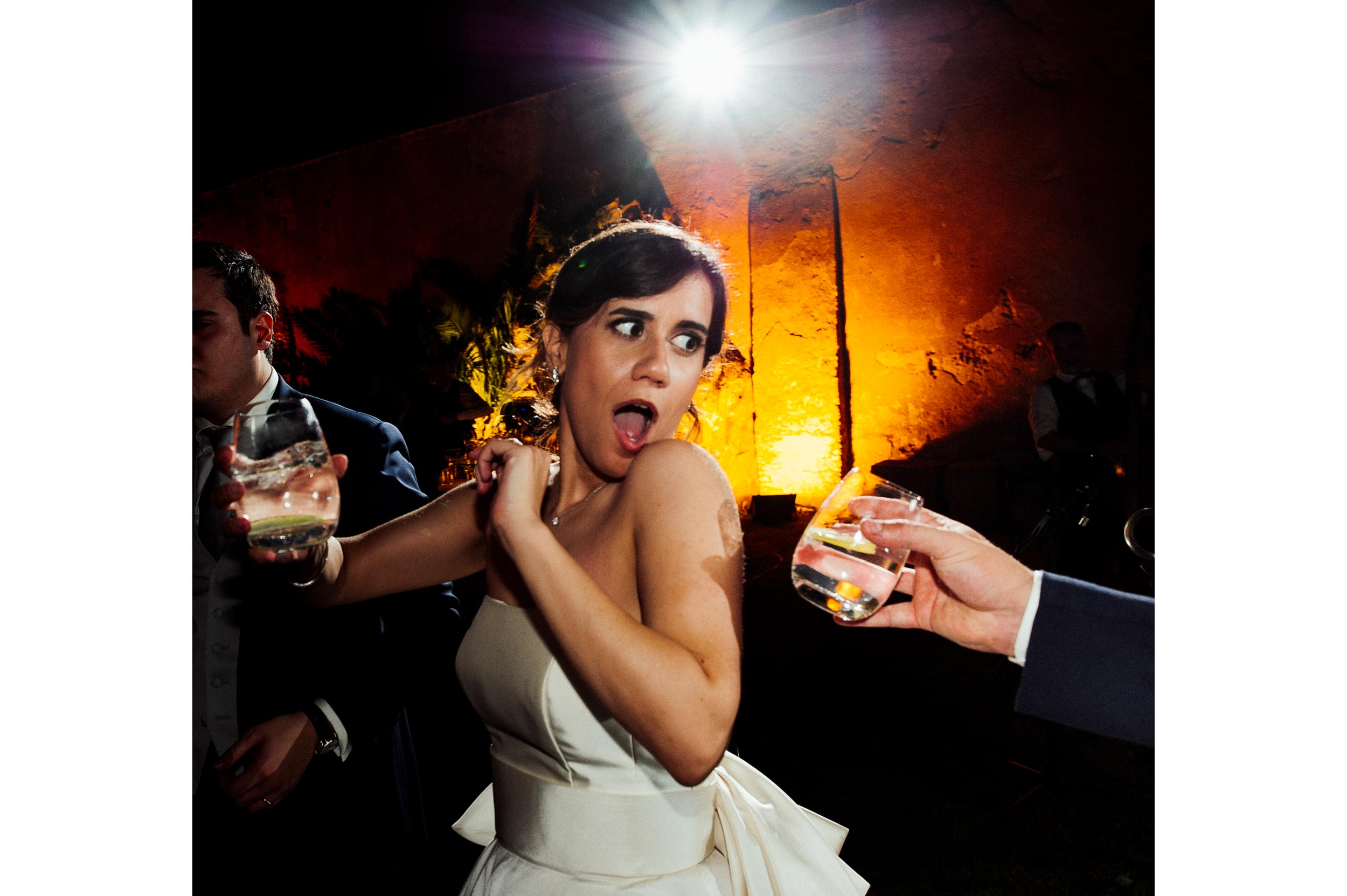 Bride refusig water during wedding party candid wedding photography by Alessandro Avenali
