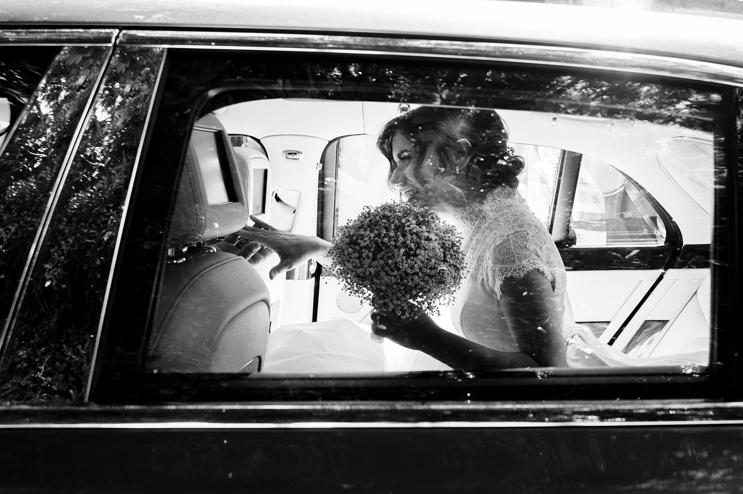elegant bride in car with bouquet italian wedding in rome photographer alessandro avenali