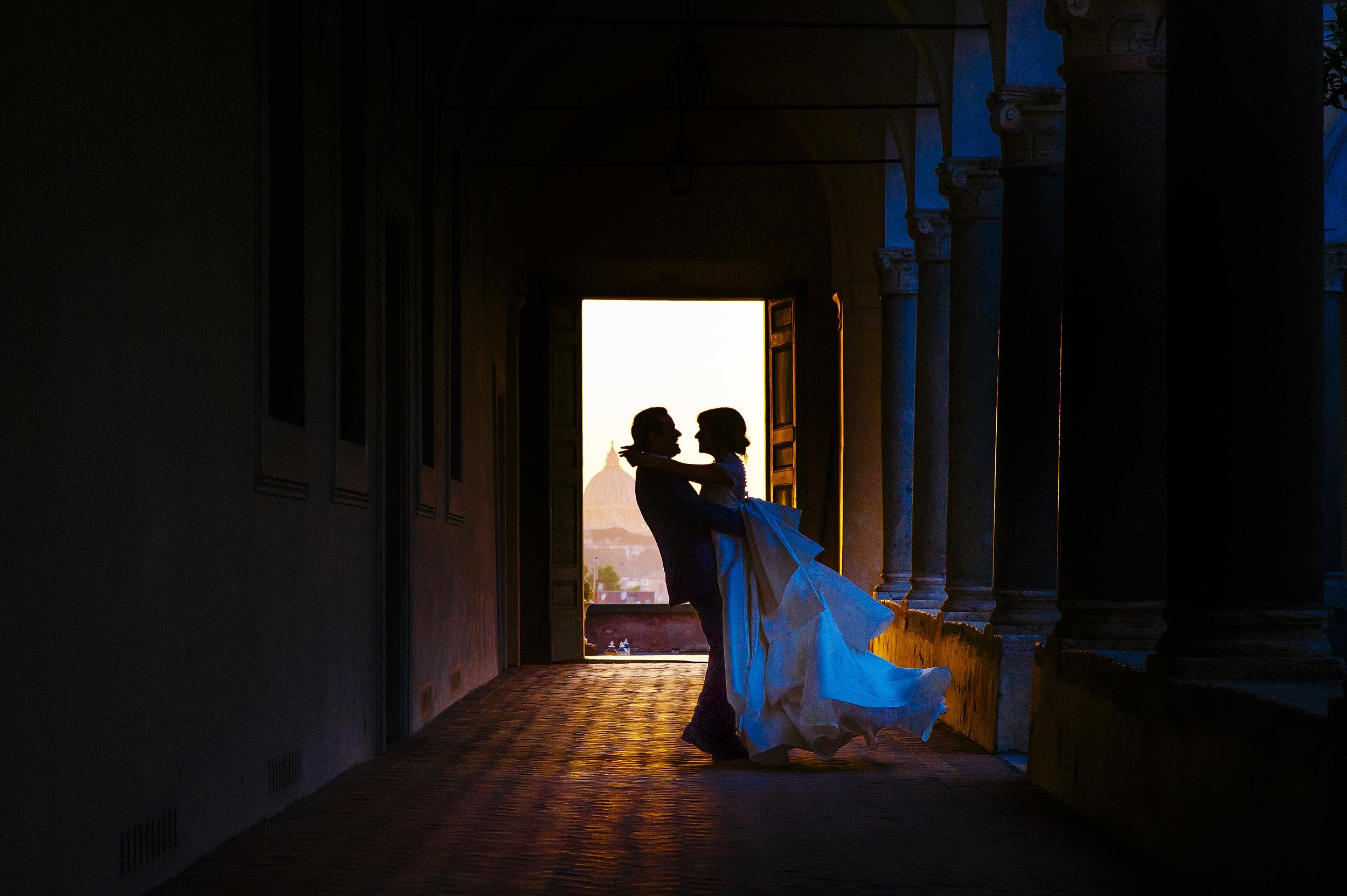 wedding in rome sunset portrait of bride and groom spinning around complementary colors orange and blue