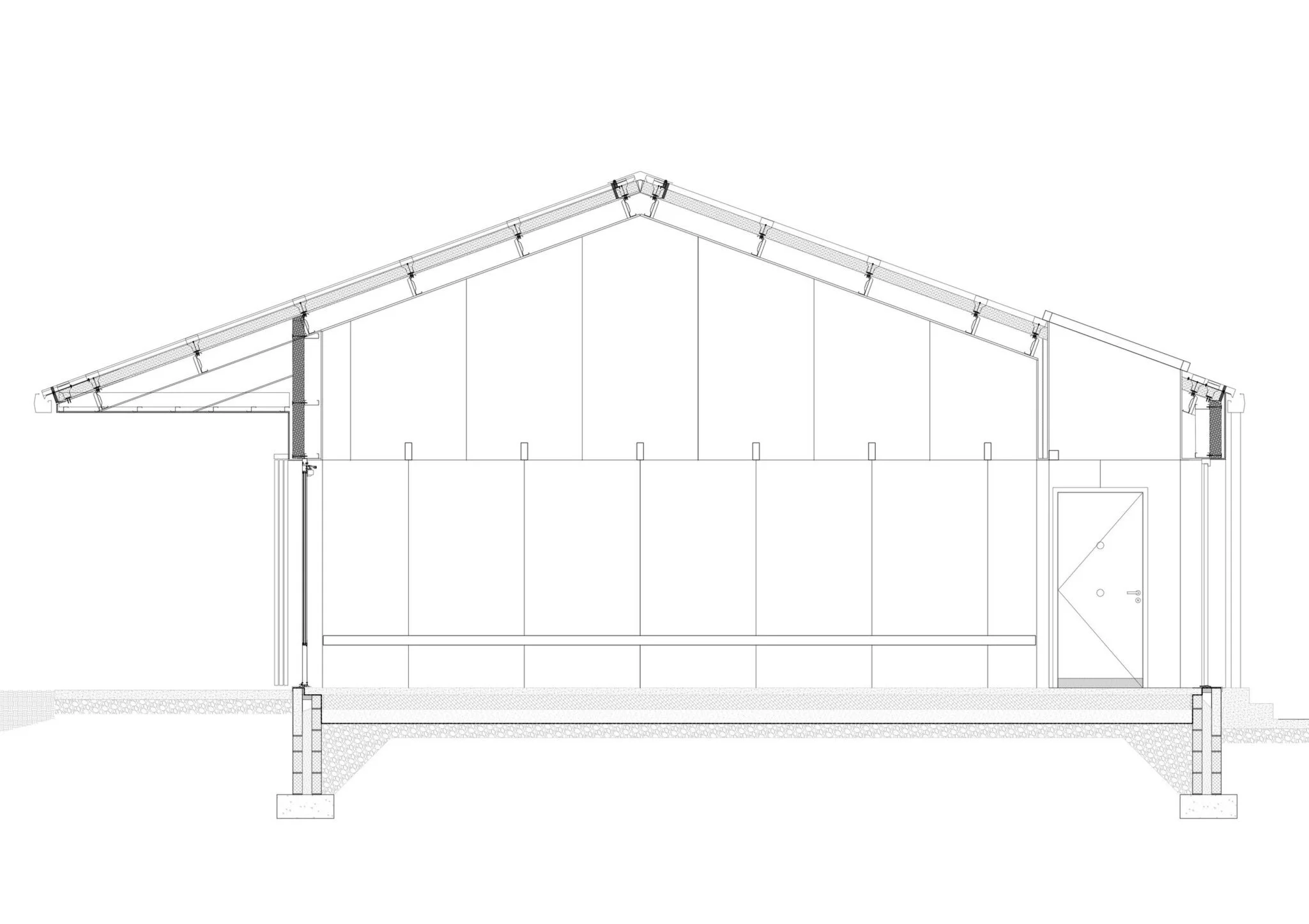 Architectural section drawing of a building with a pitched roof, structural details, and foundation.