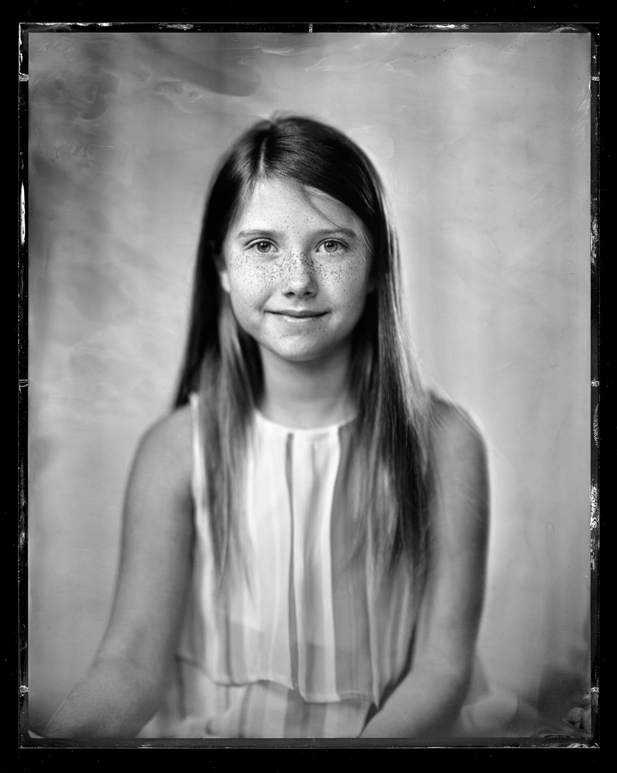 29-families-girl-with-long-straight-hair-and-a-faint-smile-in-a-pale-top-a79.jpg