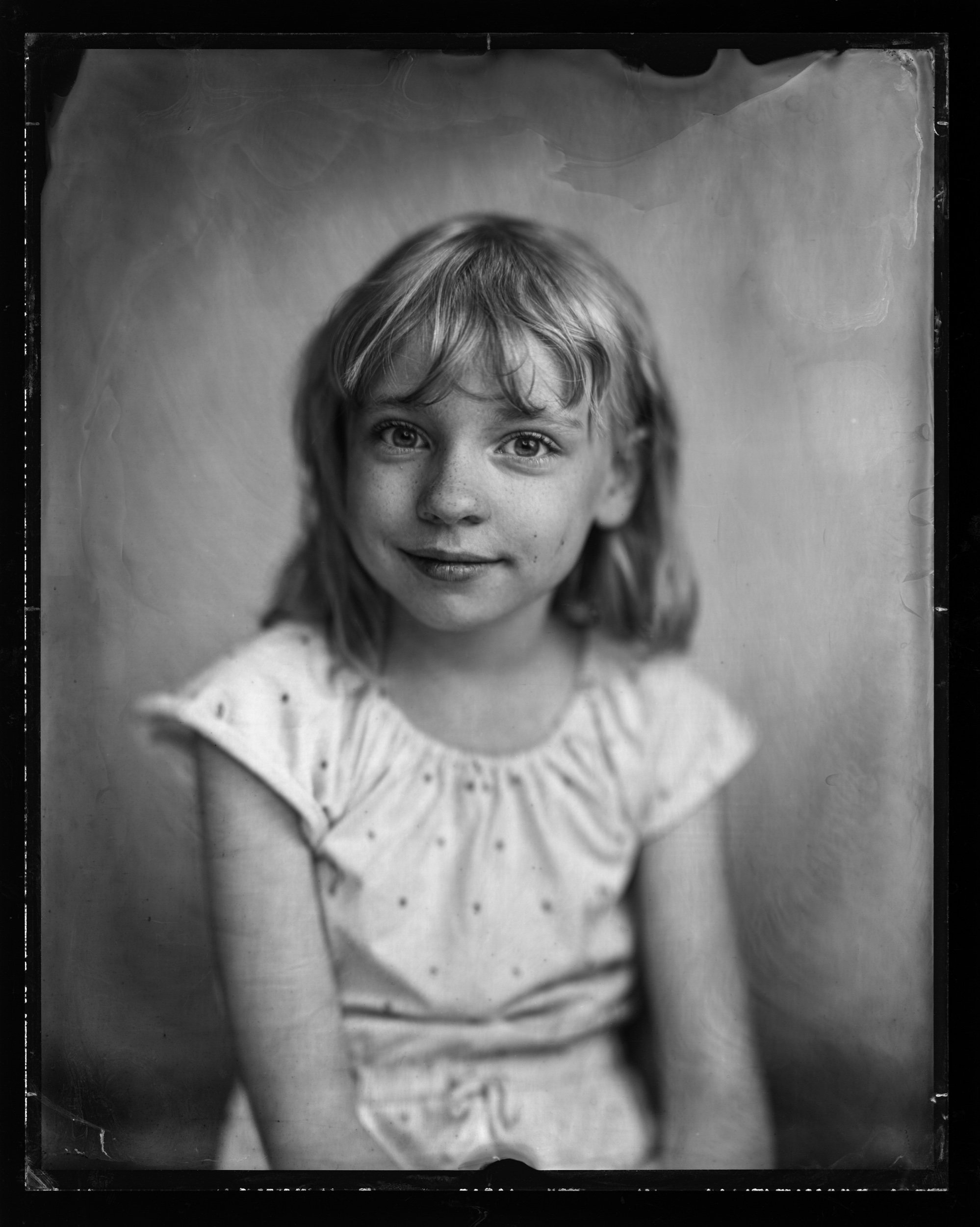 31-families-small-girl-grinning-in-a-white-eyelet-blouse-hand-poured-a82.jpg