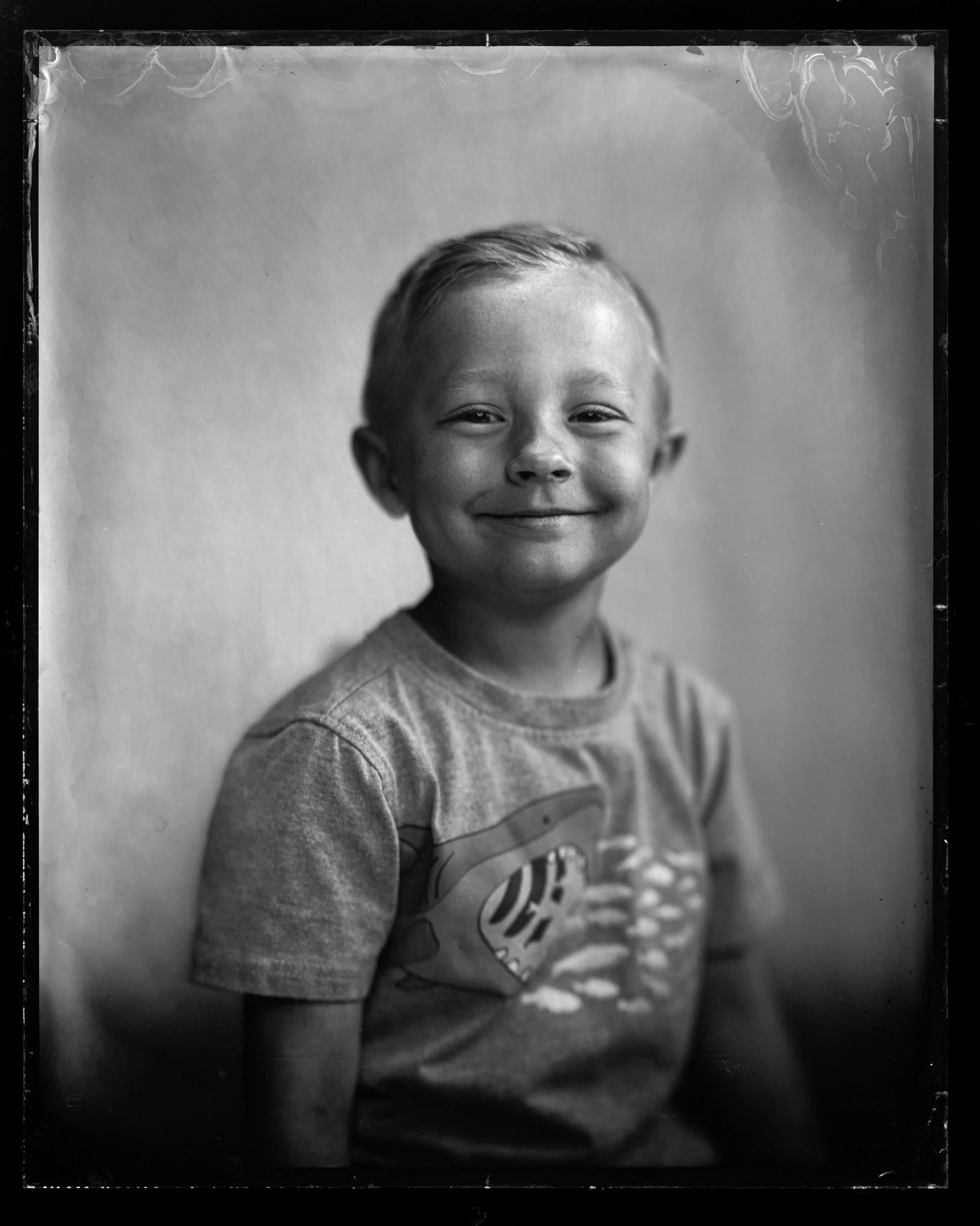 32-families-boy-in-a-graphic-t-shirt-breaking-into-a-wide-grin-a83.jpg