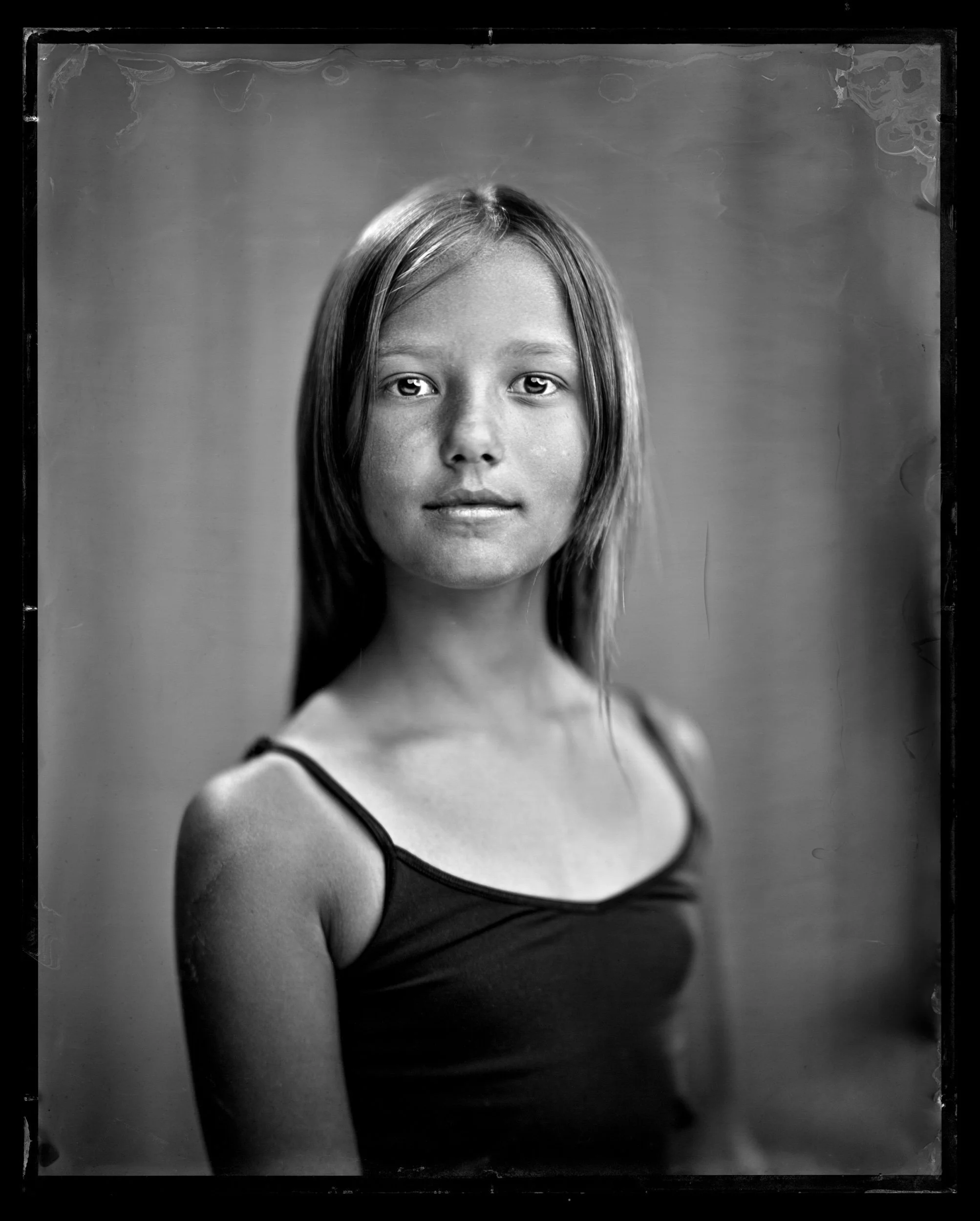 33-families-girl-in-a-black-tank-top-with-long-loose-hair-and-a-level-gaze-a84.jpg