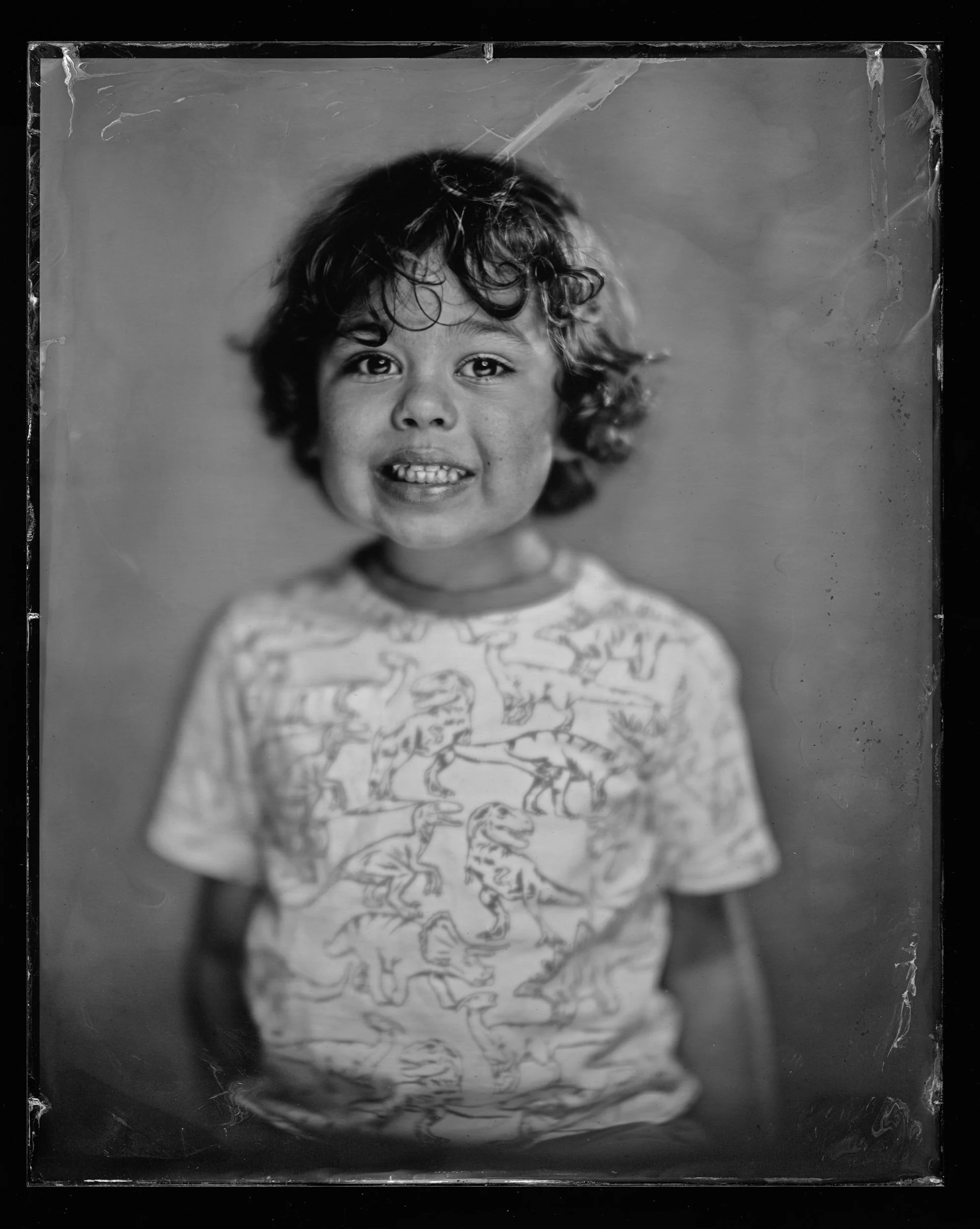34-families-curly-haired-child-laughing-in-a-patterned-t-shirt-tintype-a86.jpg