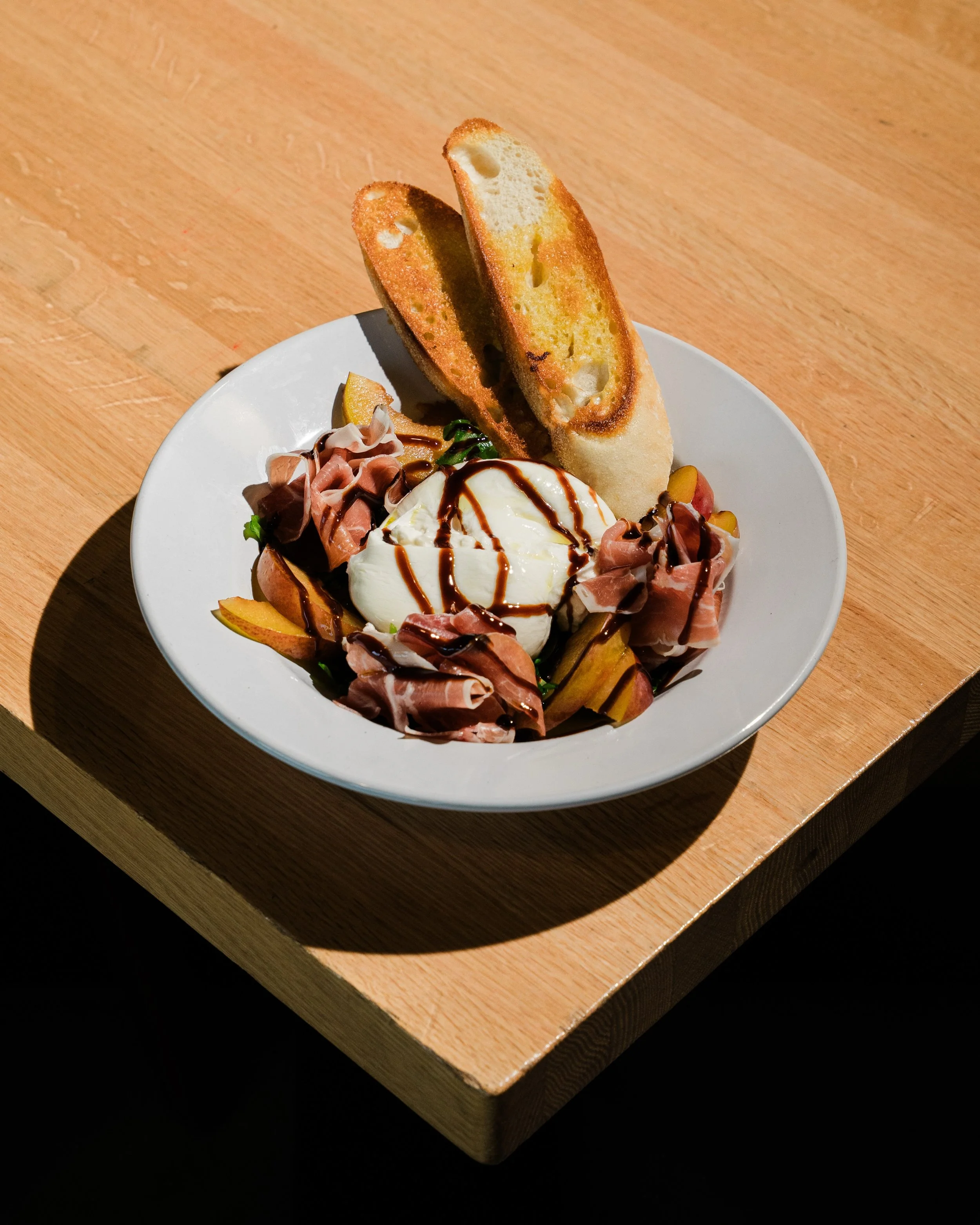 Fresh on the menu! 🍽️ What are you ordering first?

Three new plates just hit the kitchen lineup:

🍽️ Burrata: creamy burrata with stone fruit, prosciutto, arugula, balsamic reduction and EVOO, served with crostini for scooping
🍽️ Blackened Salmon